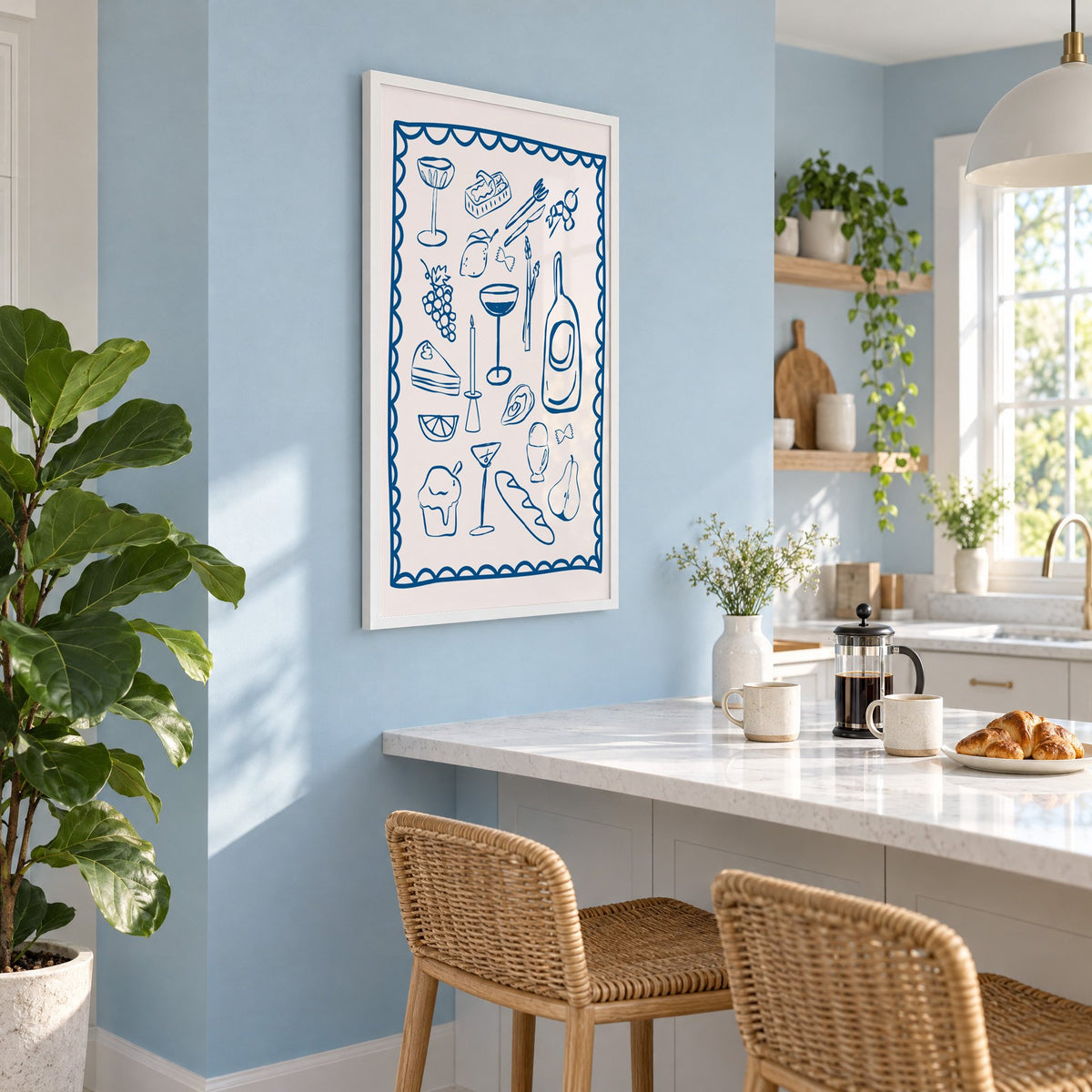 Blue line dinner party scalloped print in a white frame on a pale blue wall above a breakfast bar with rattan stools