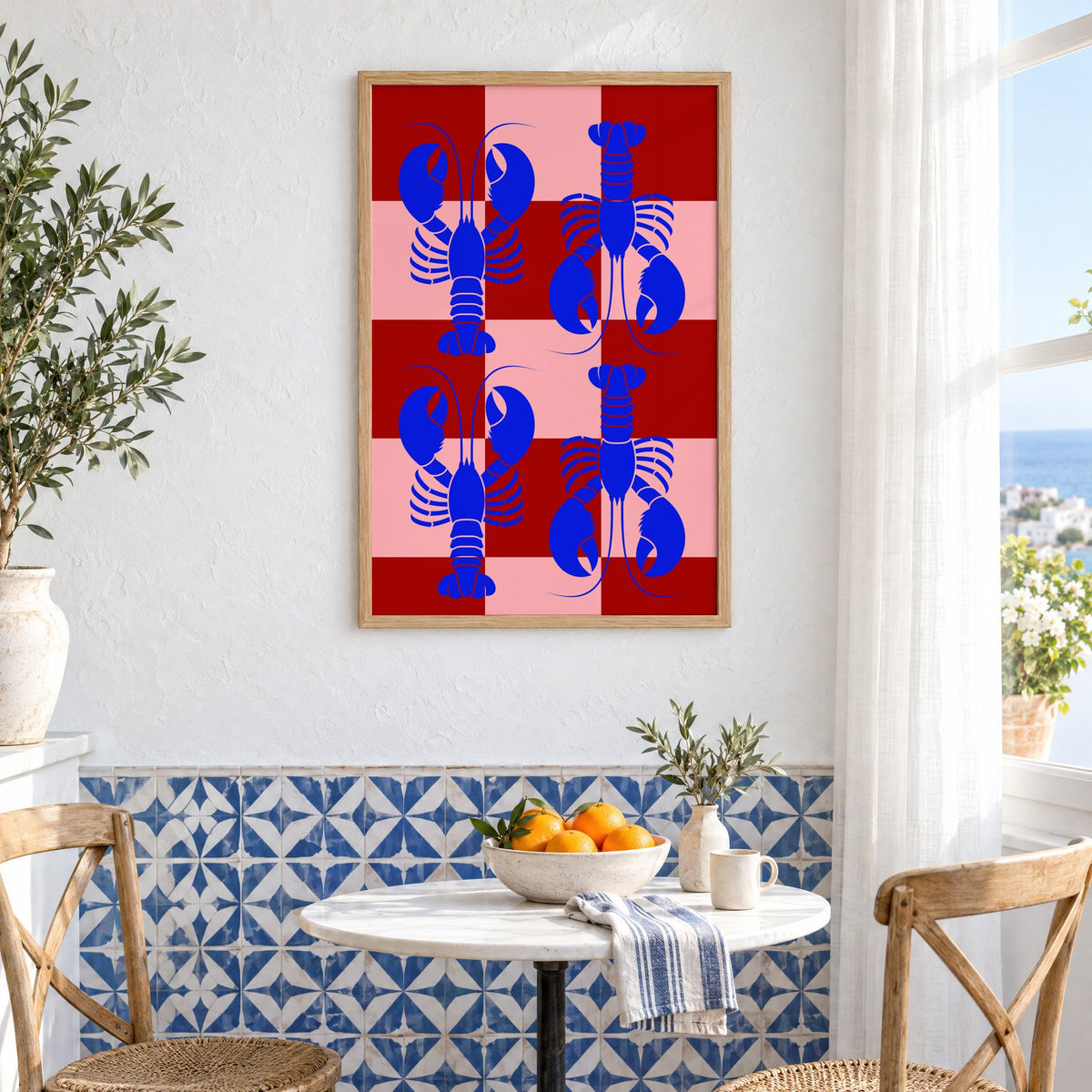Blue lobster red pink checker print in an oak frame above a bistro table and blue patterned tiles