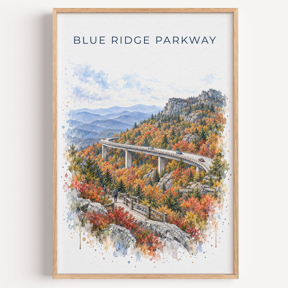 Blue Ridge Parkway watercolor print in a light oak frame on a plain white wall
