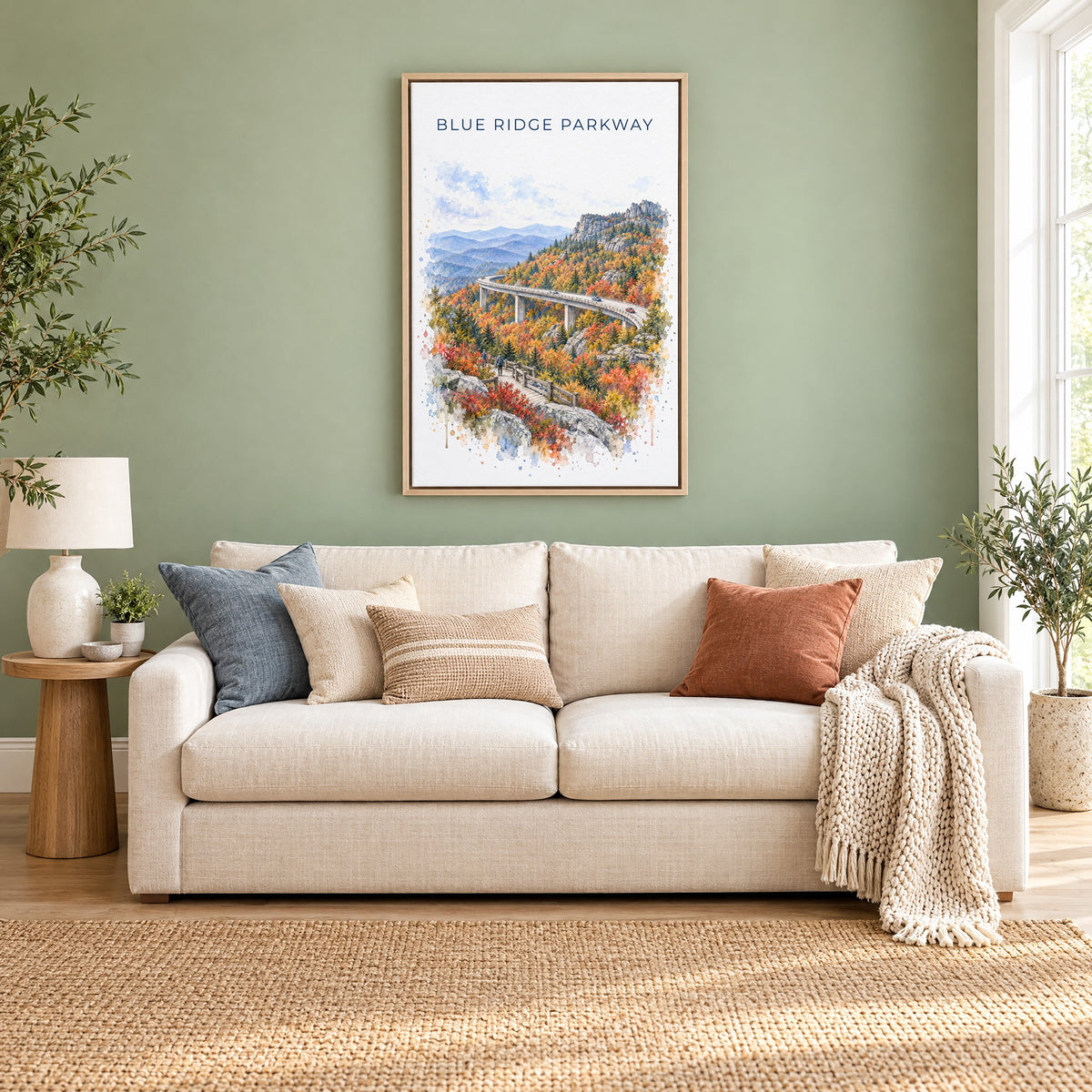 Blue Ridge Parkway watercolor print as a natural floater canvas above a cream linen sofa on a sage green wall