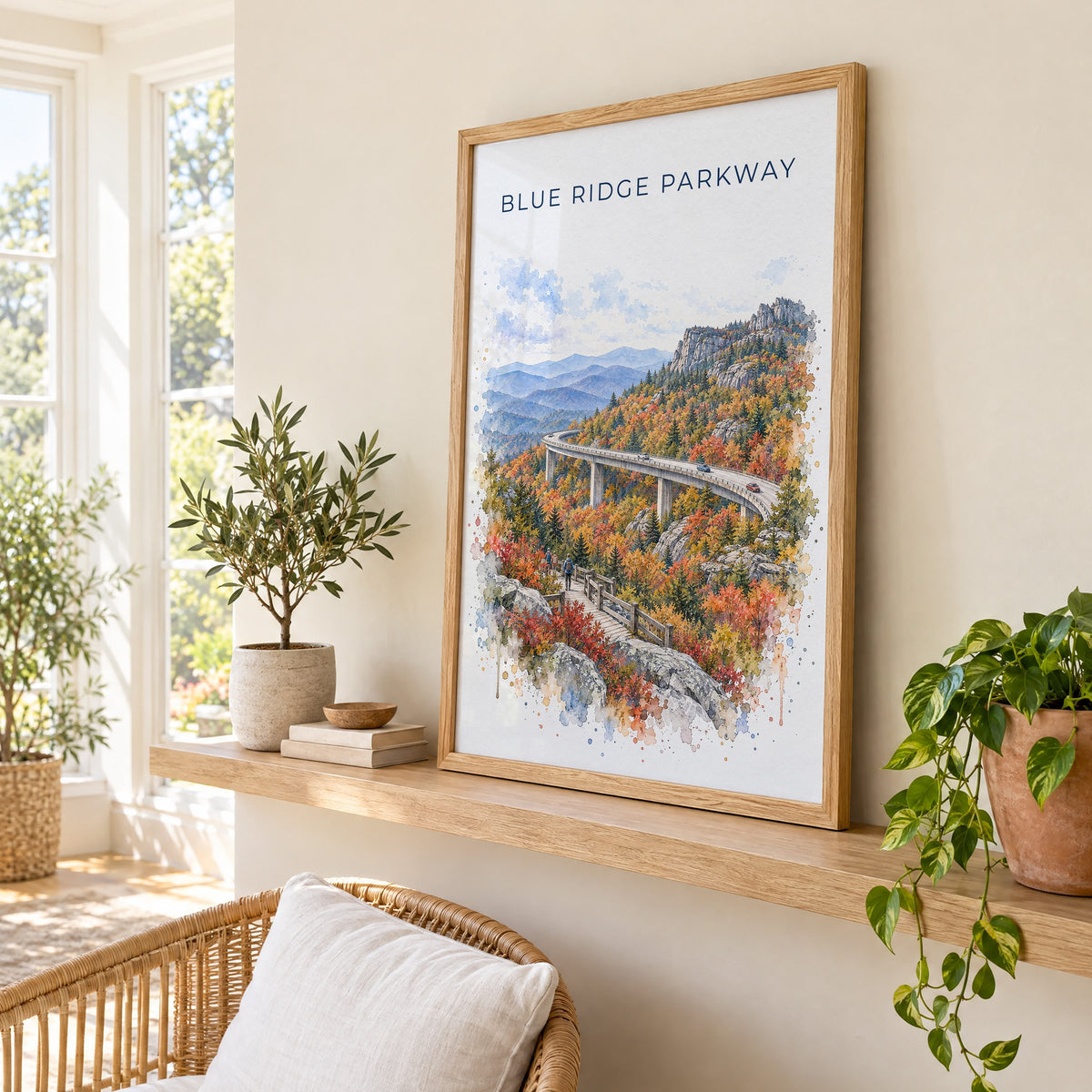 Blue Ridge Parkway watercolor print in an oak frame on a picture ledge in a sunlit sunroom