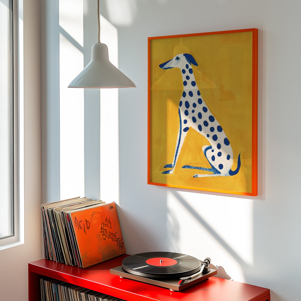 Mustard yellow dog print shown in an orange frame above a red record cabinet and turntable