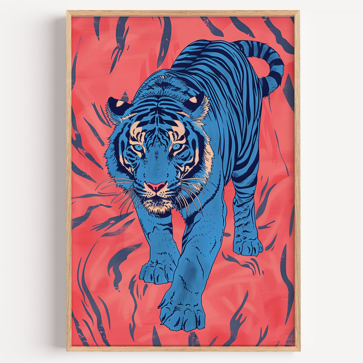 Blue tiger on coral pink print in a light oak frame on a plain white wall
