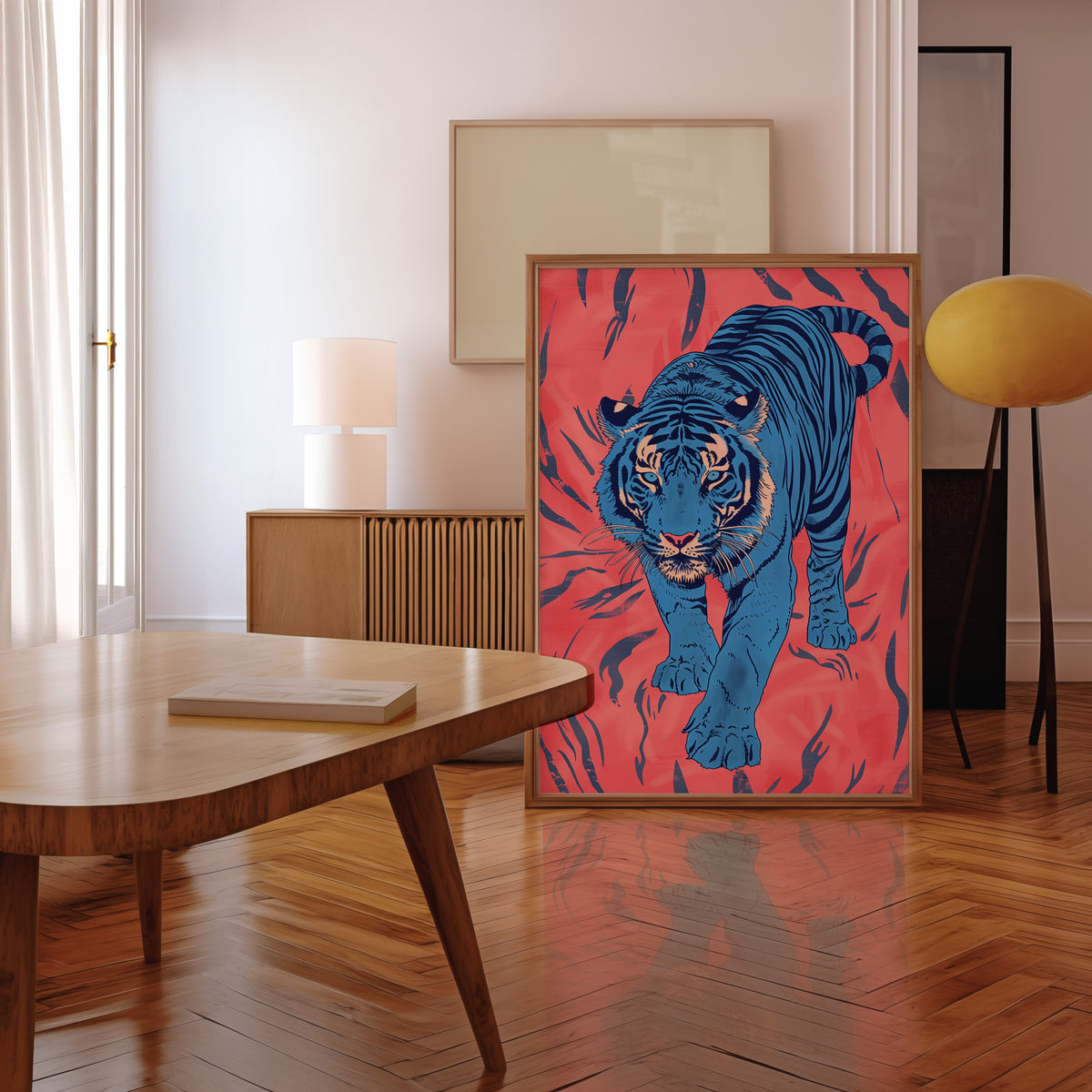 Blue tiger on coral pink print in a walnut frame leaning in a mid-century living room