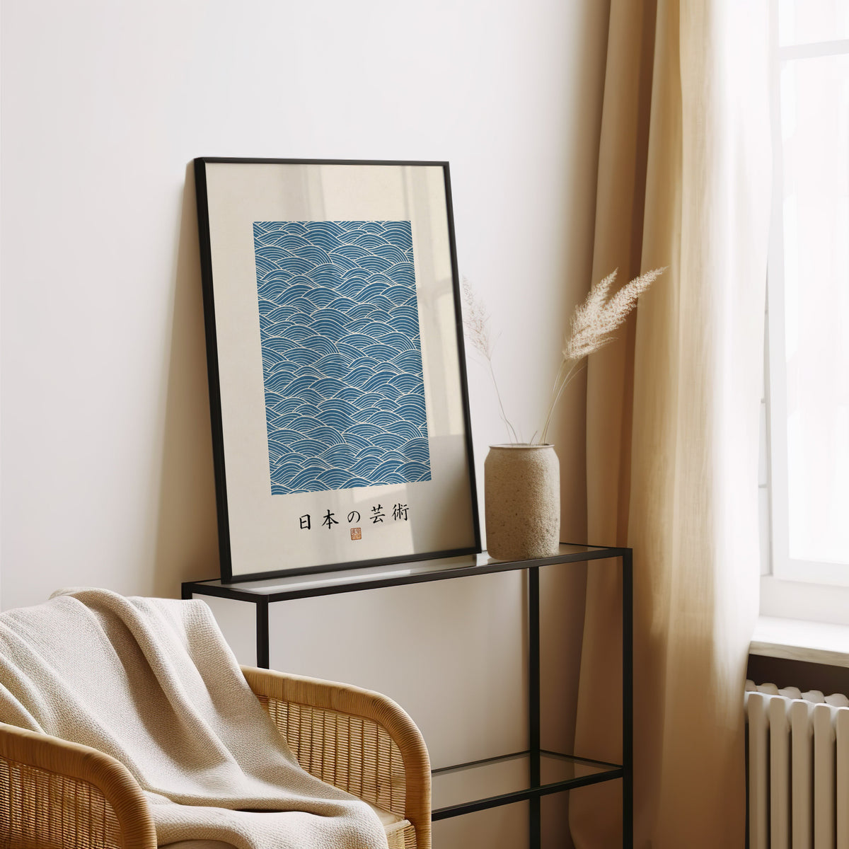Blue wave line pattern poster in a black frame leaning on a glass console beside pampas grass
