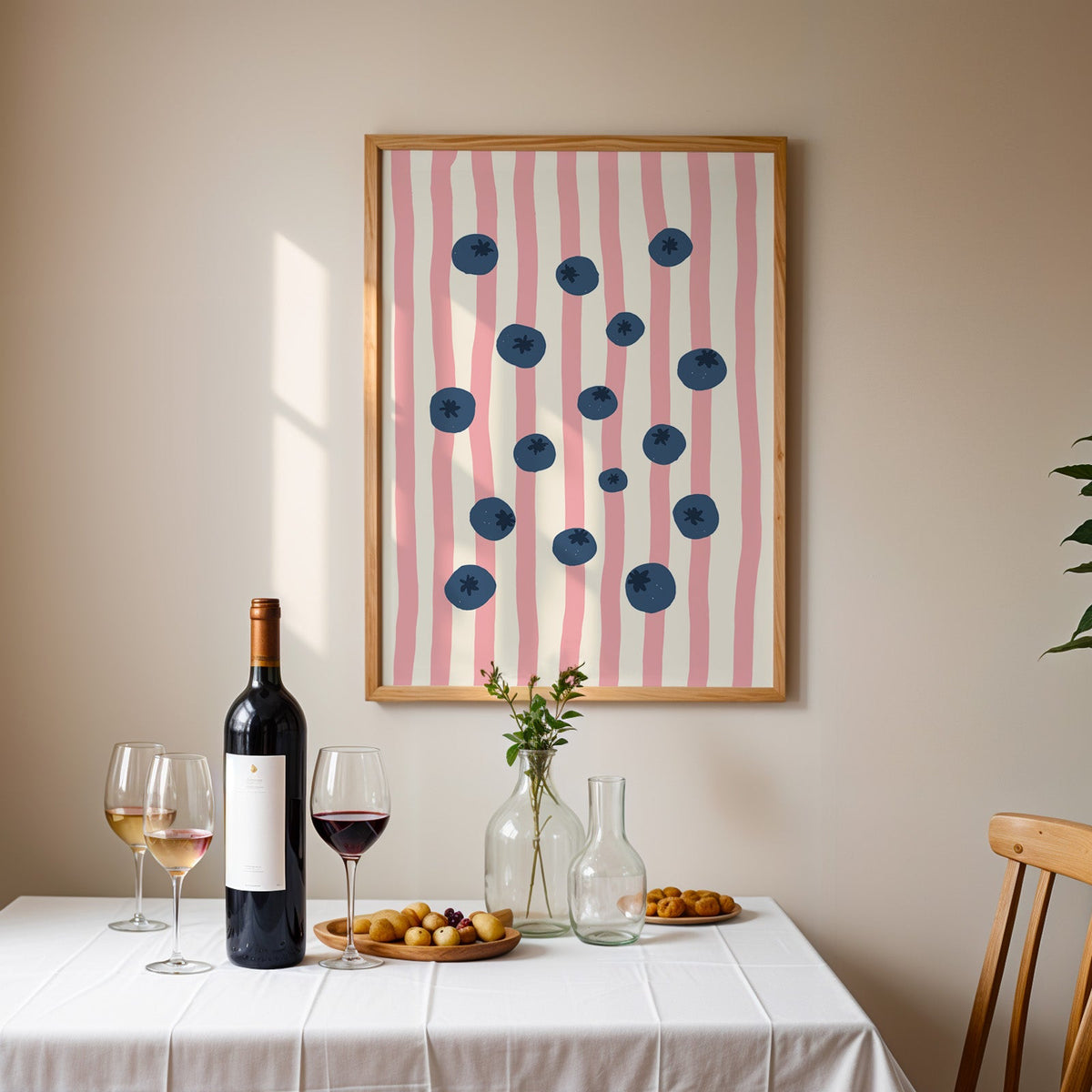 Blueberry stripe print in an oak frame above a table laid with red wine and glasses