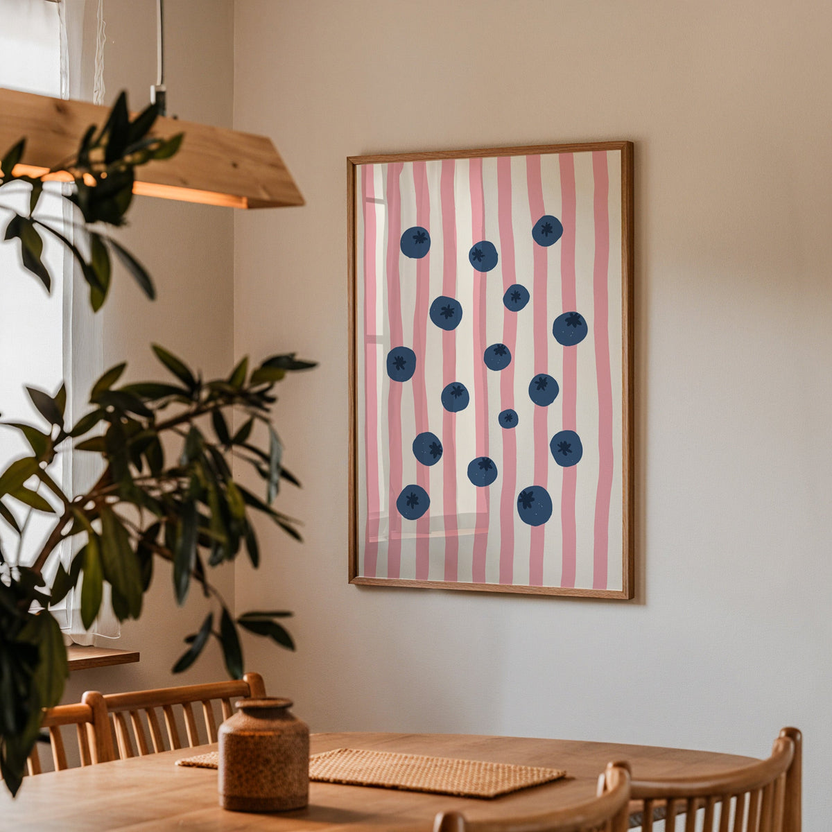 Blueberry stripe print in a walnut frame above a dining table beside an olive tree