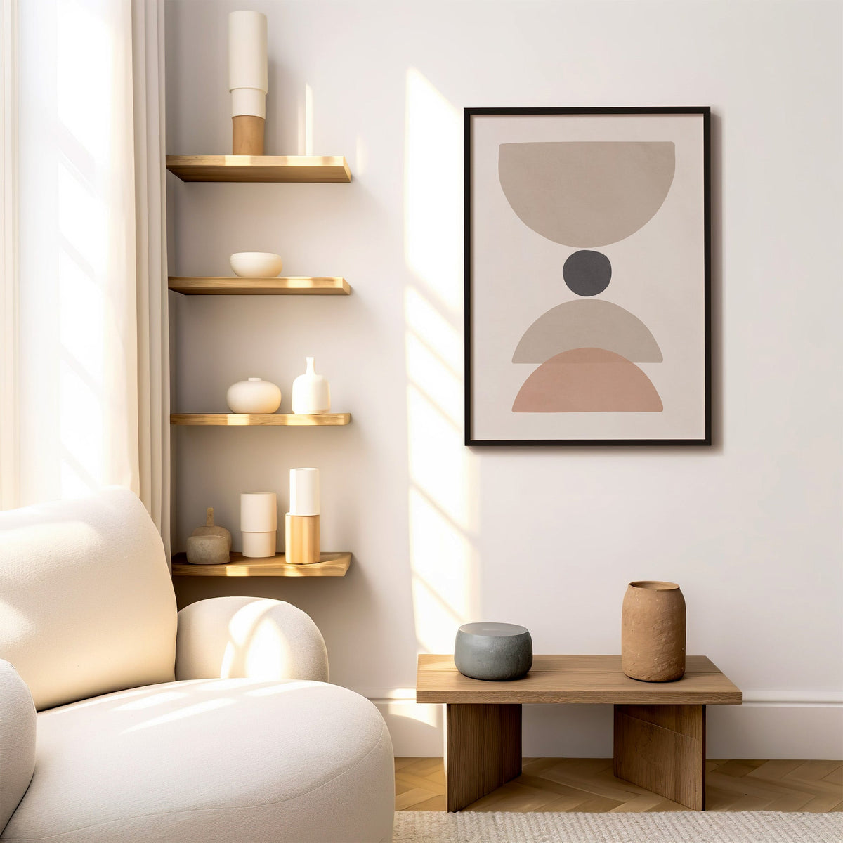 Taupe bowl, charcoal dot and blush arch print in a black frame above a low wood bench beside floating oak shelves