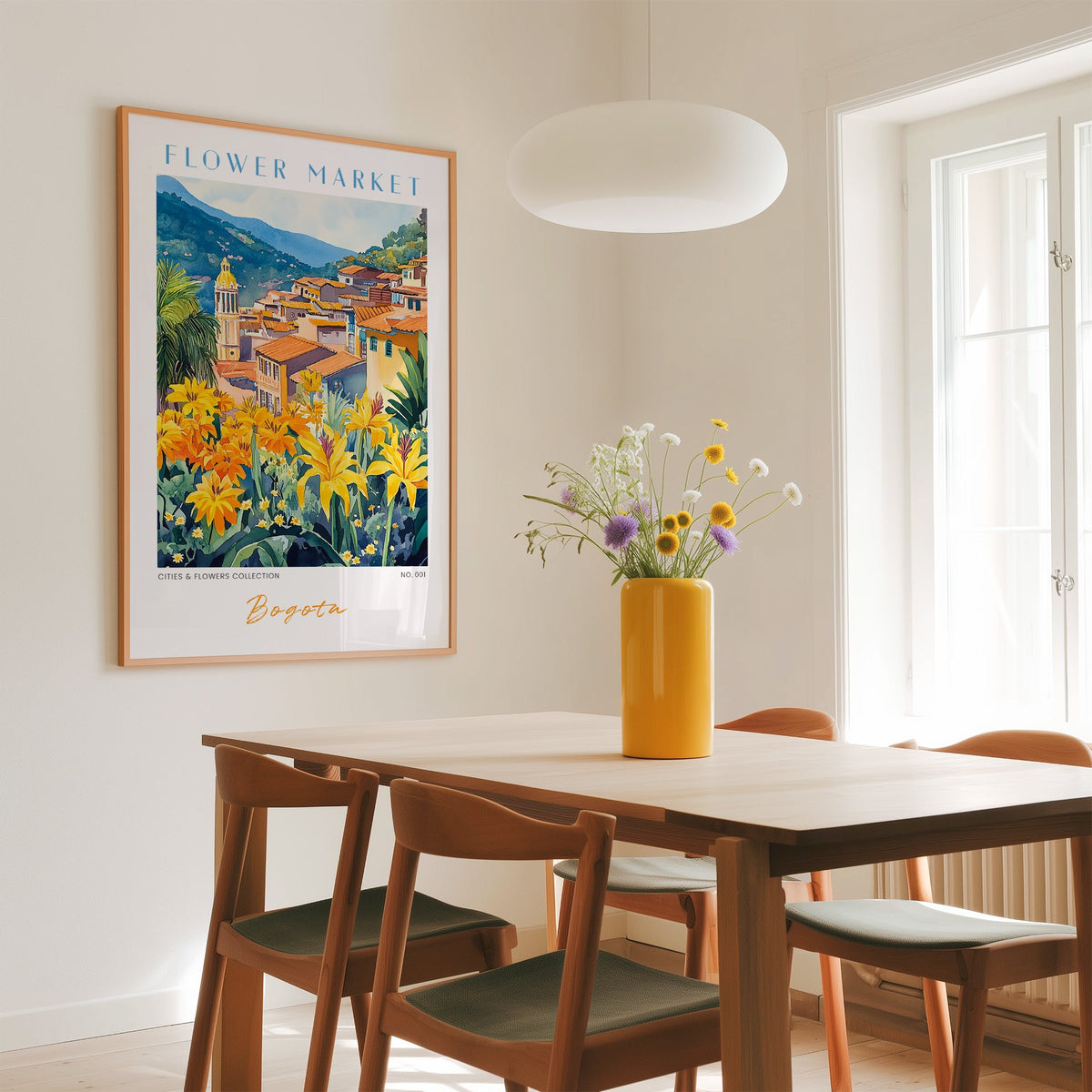 Bogota flower market print in an oak frame above a dining table with a yellow vase and white pendant light