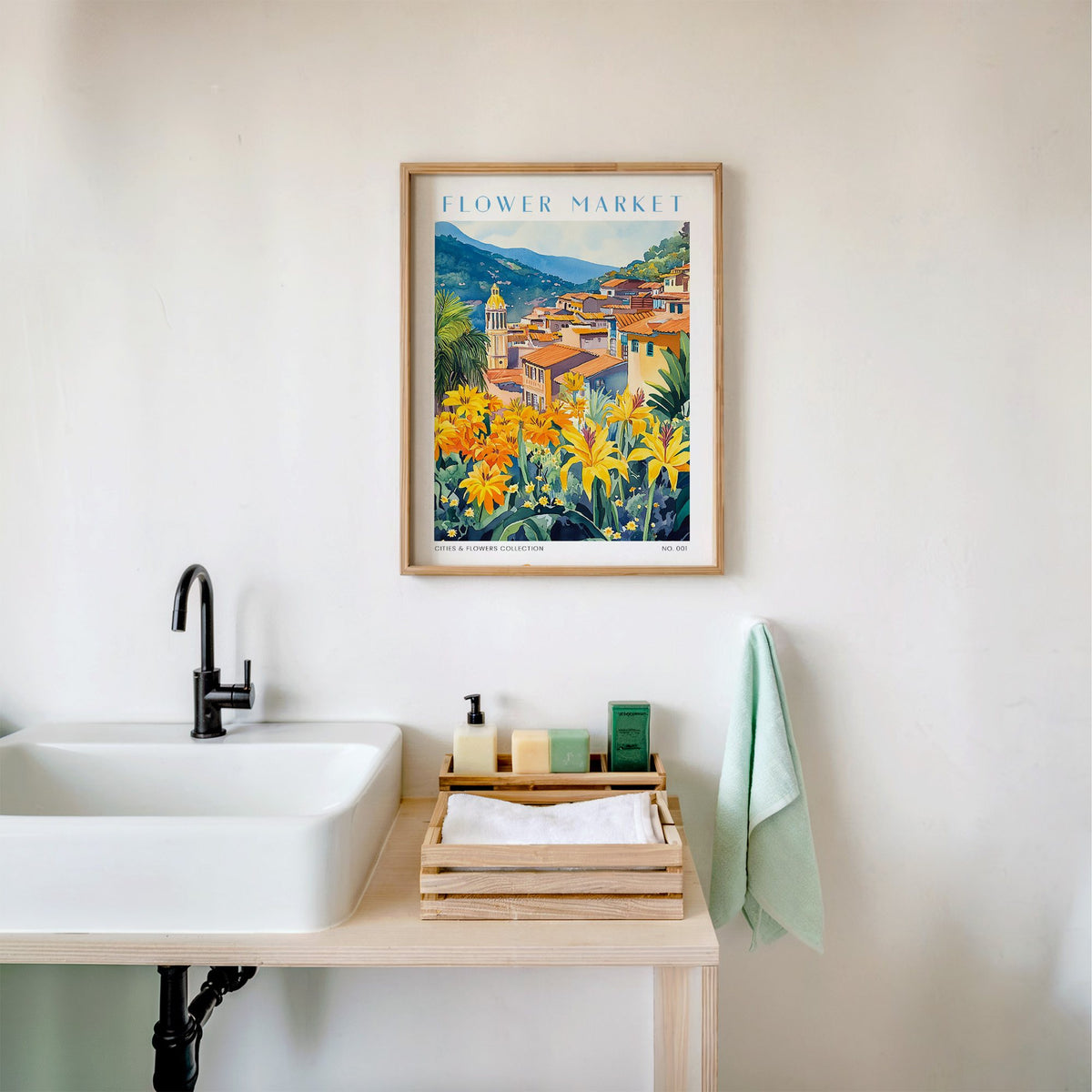 Bogota flower market print in an oak frame above a white bathroom sink with folded towels