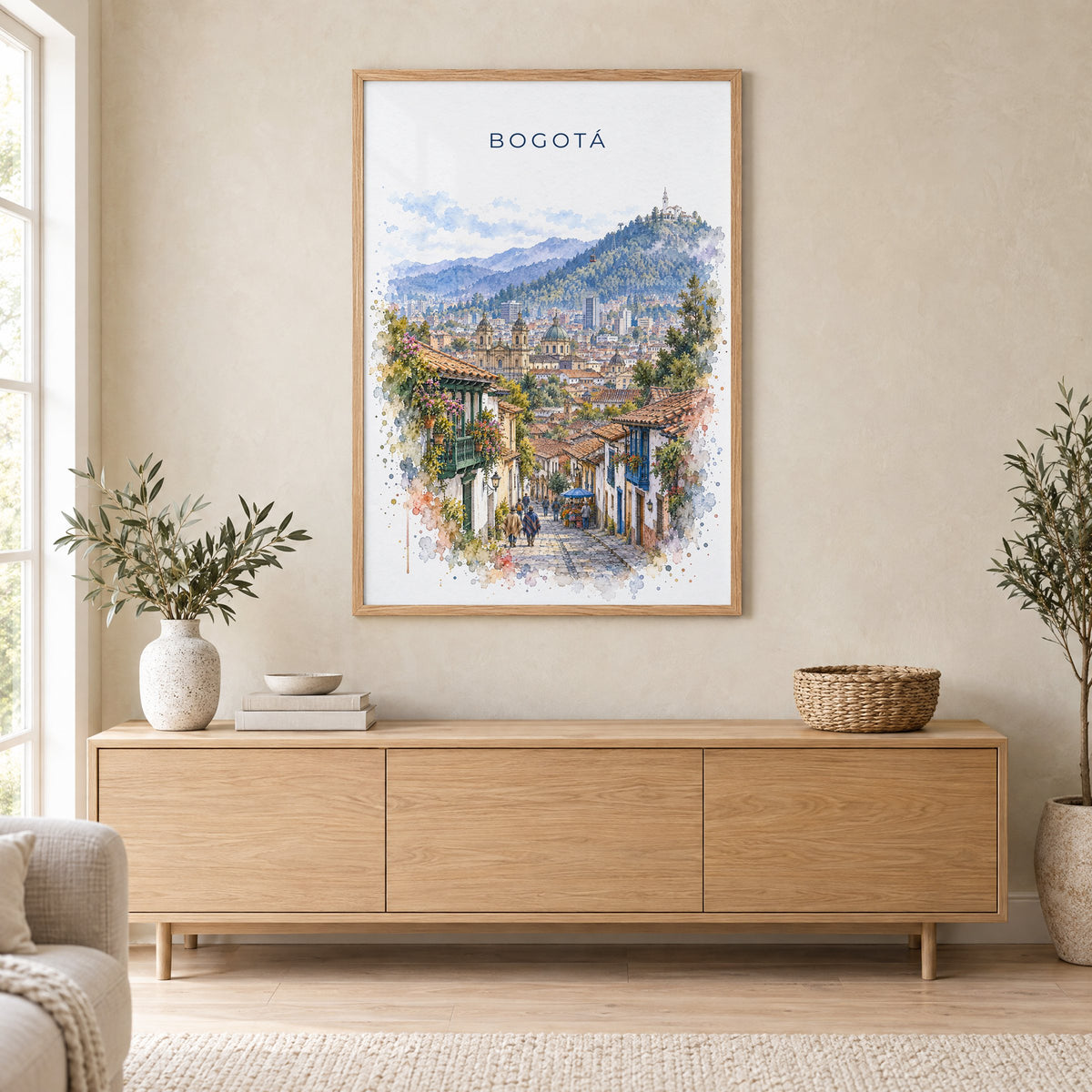 Bogotá watercolor print in an oak frame above a light wood sideboard in a Scandinavian living room