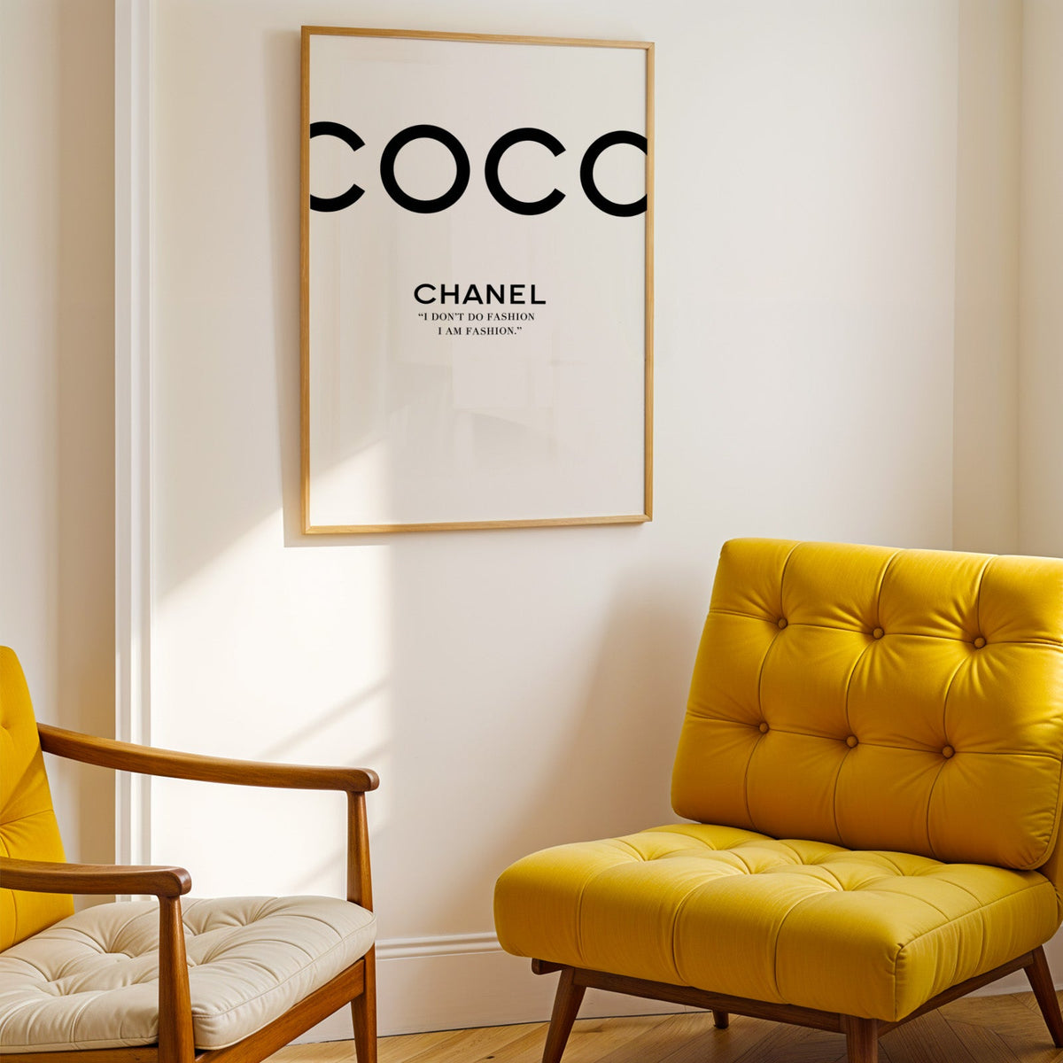 Giant cropped black letters with fashion quote print shown in a gold frame above a mustard yellow tufted armchair