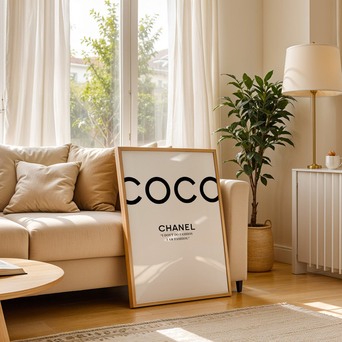 Giant cropped black letters with fashion quote print in a light oak frame leaning on a cream sofa beside a floor lamp