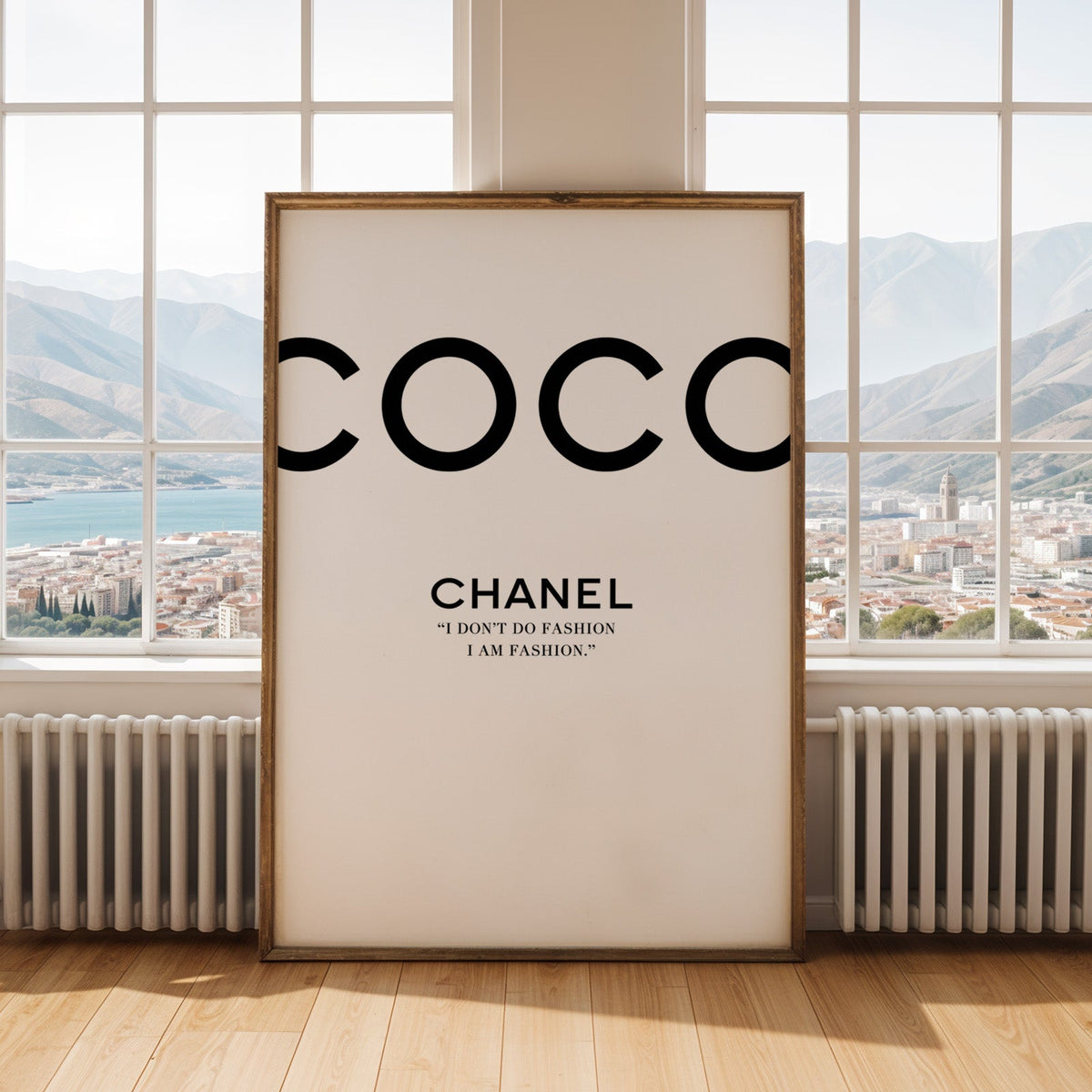 Giant cropped black letters with fashion quote print shown in an antique gold frame by tall windows with a sea view
