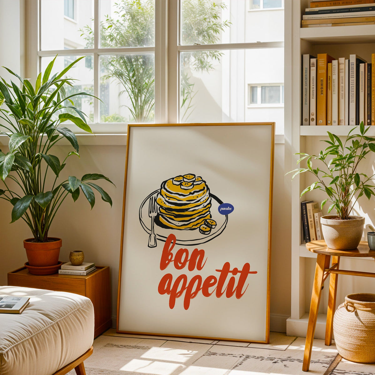 Bon Appetit pancakes print in a brass frame resting on a berber rug