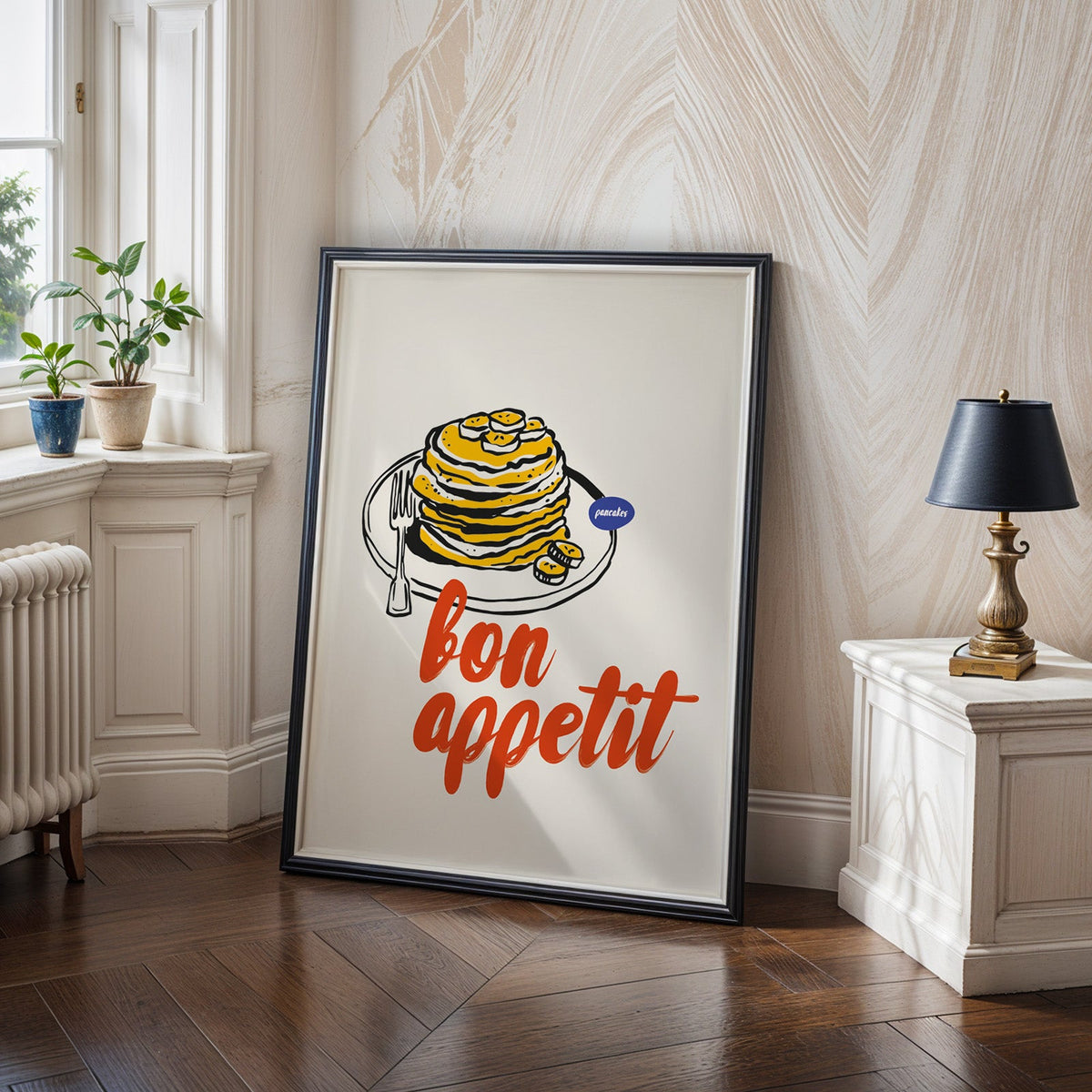 Bon Appetit pancakes print in a black frame on a dark herringbone floor