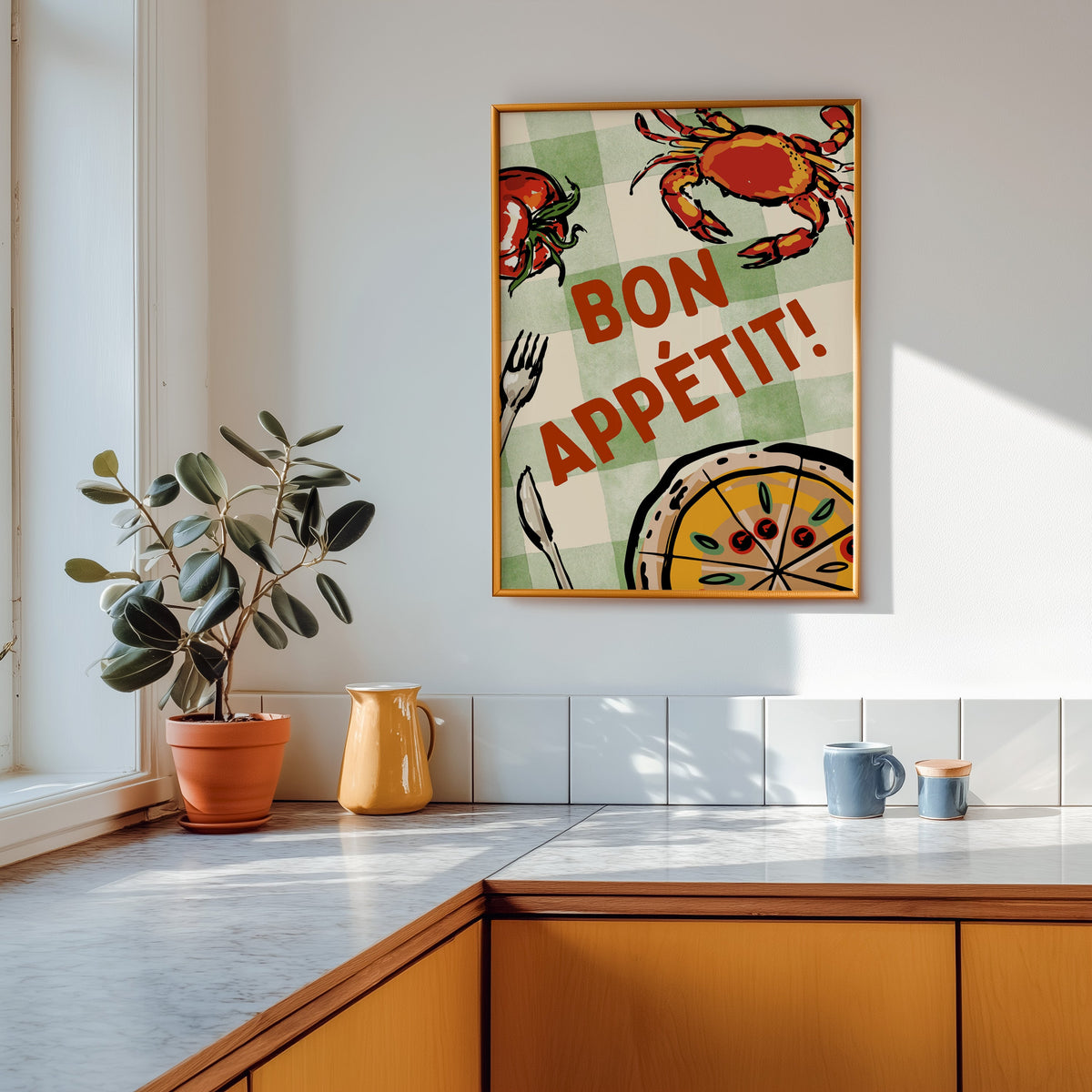 Bon Appetit crab print shown in a gold frame above a marble counter with a yellow ceramic jug