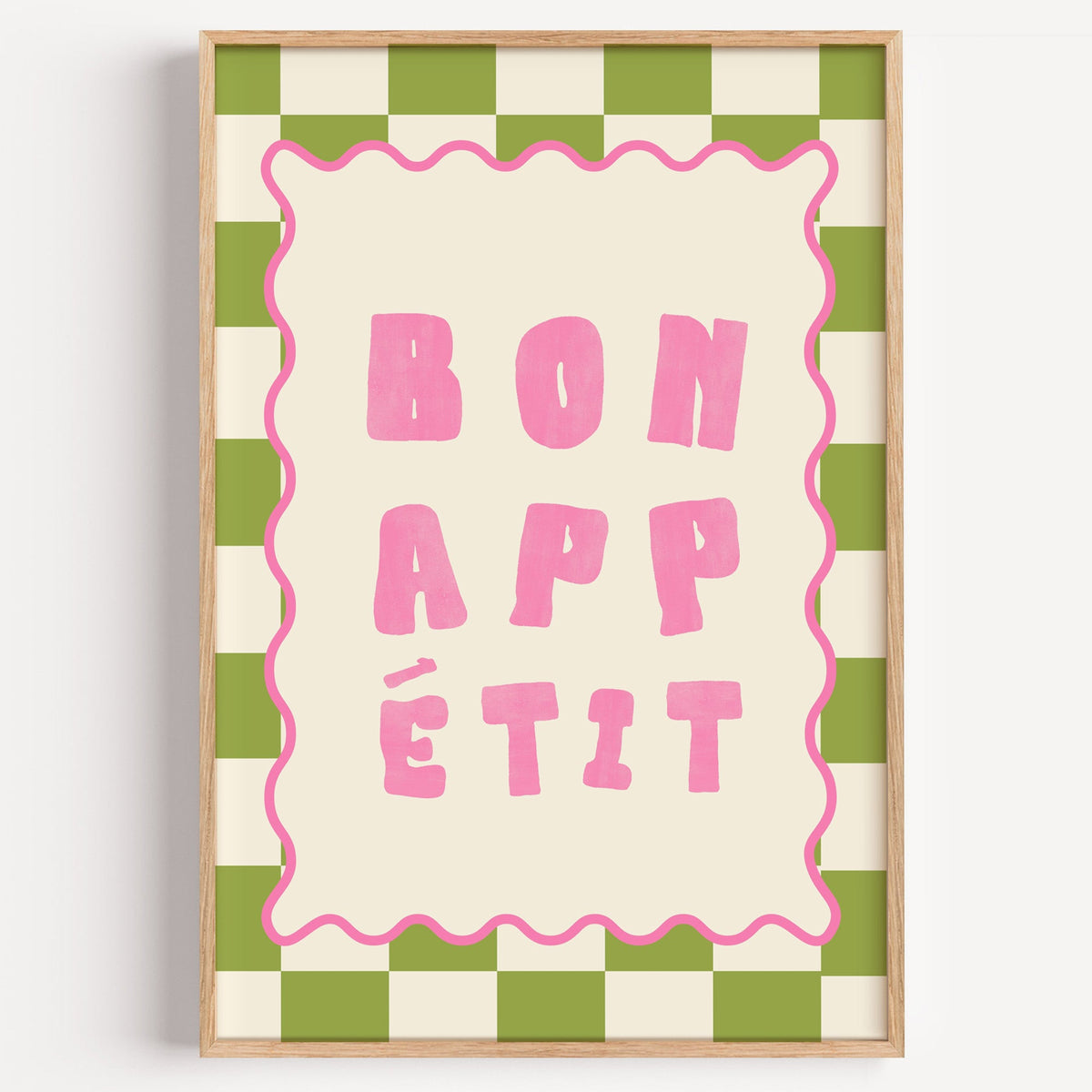 Bon Appetit green check typography print in a light oak frame on a plain white wall