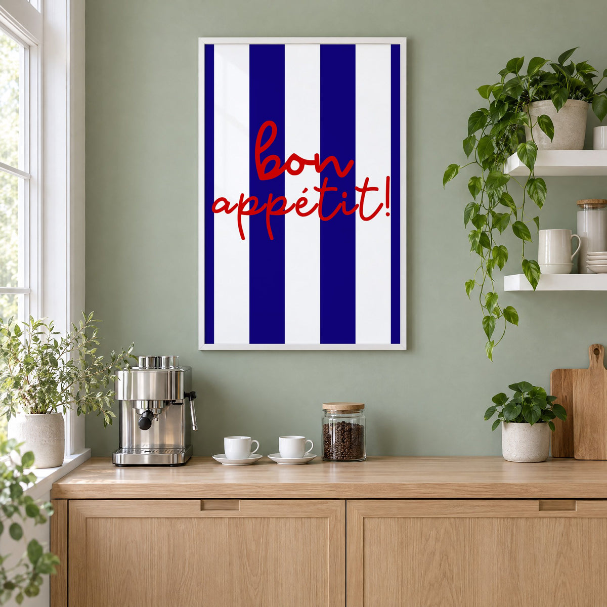 Bon appétit navy stripe print in a white frame on a sage green coffee nook wall above an espresso machine