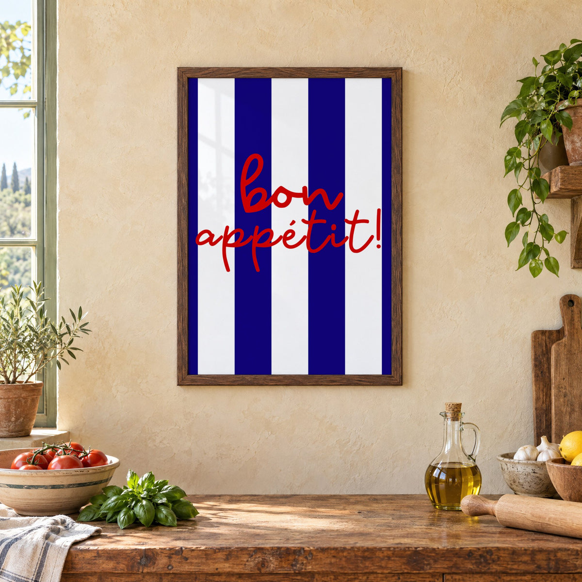 Bon appétit navy stripe print in a walnut frame above a rustic Italian kitchen table with tomatoes