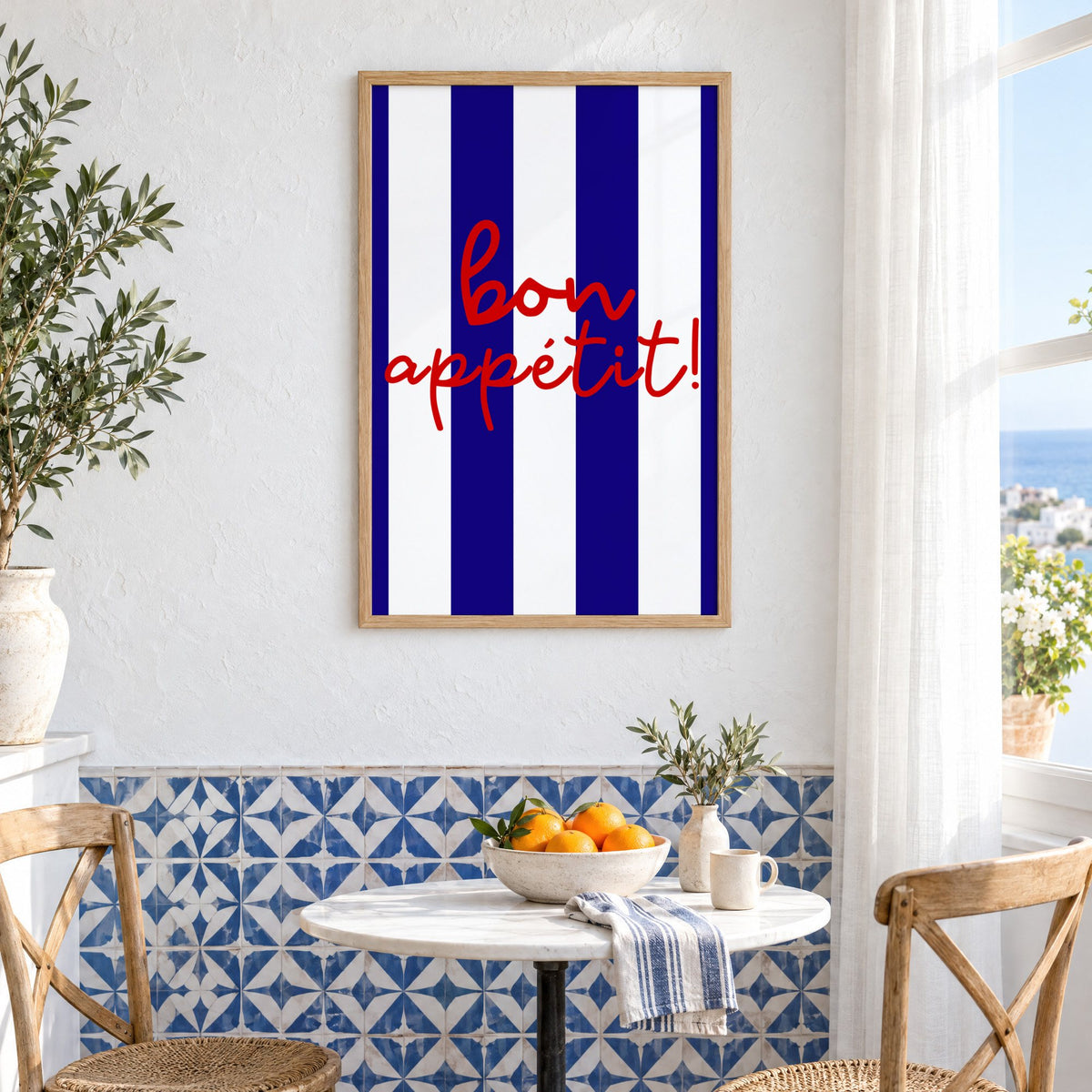 Bon appétit navy stripe print in an oak frame above a bistro table and blue patterned tiles