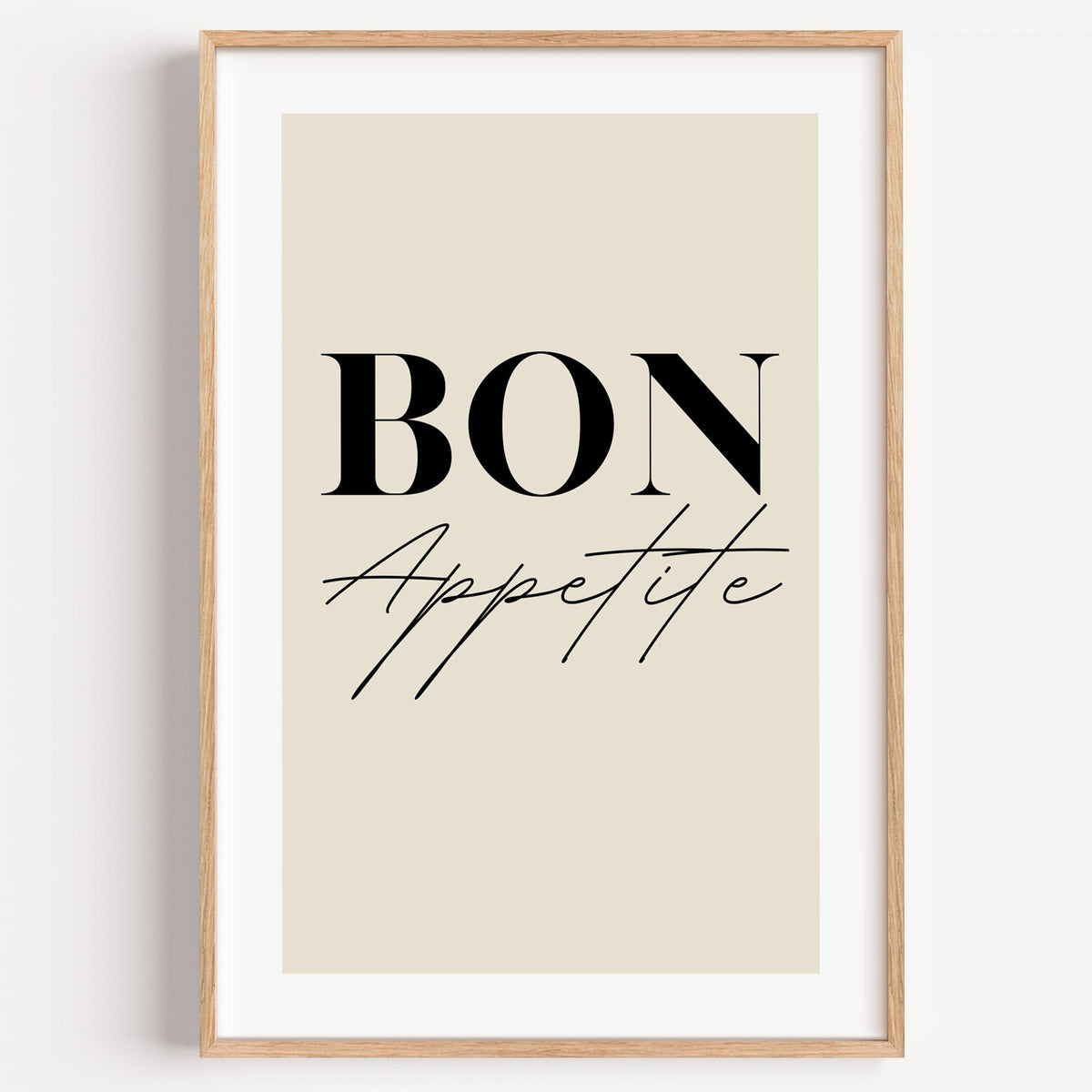 BON Appetite serif and script print in a light oak frame on a plain white wall