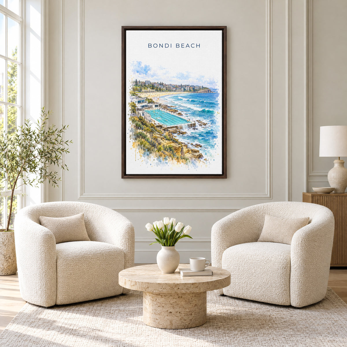 Bondi Beach watercolor print as an espresso floater canvas above two boucle armchairs in a hotel lounge
