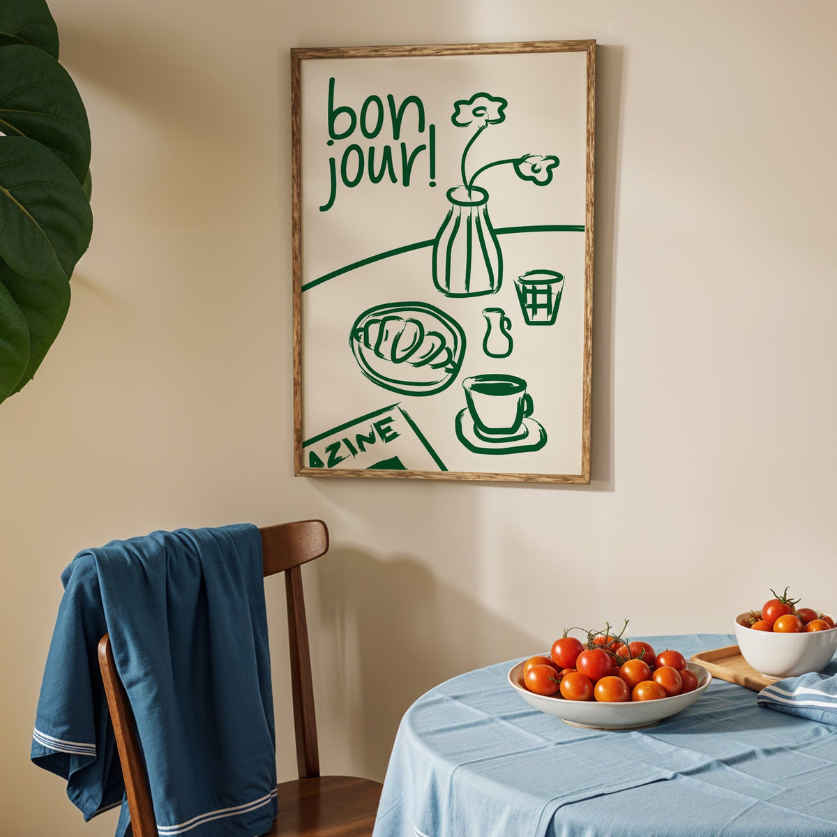 Bon jour breakfast print in an oak frame above a blue linen table with ripe tomatoes
