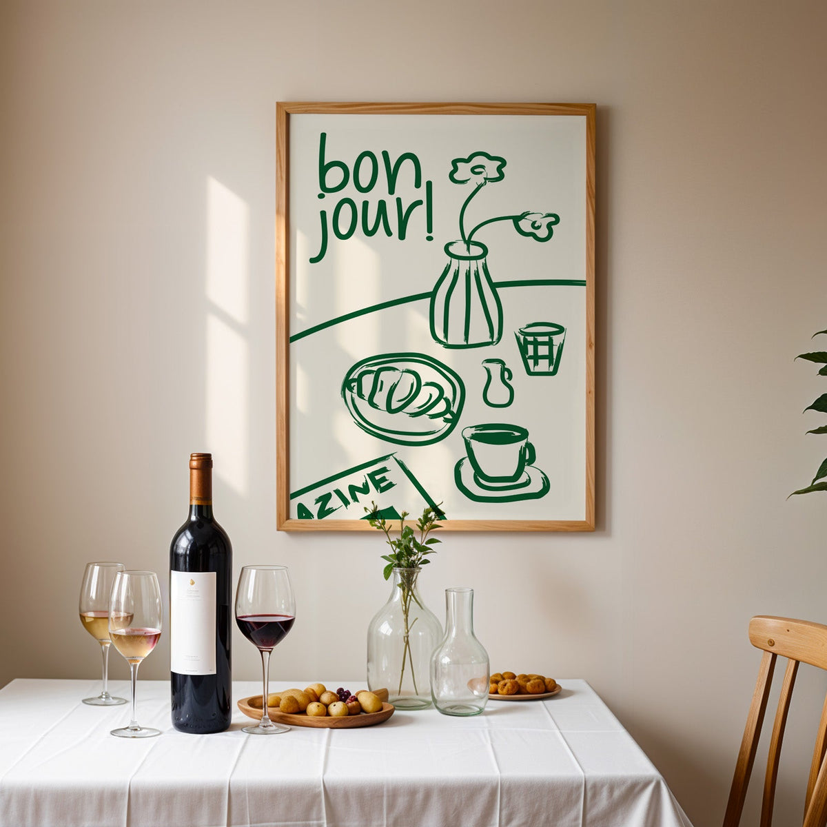 Bon jour breakfast print in an oak frame above a table laid with red wine and glasses
