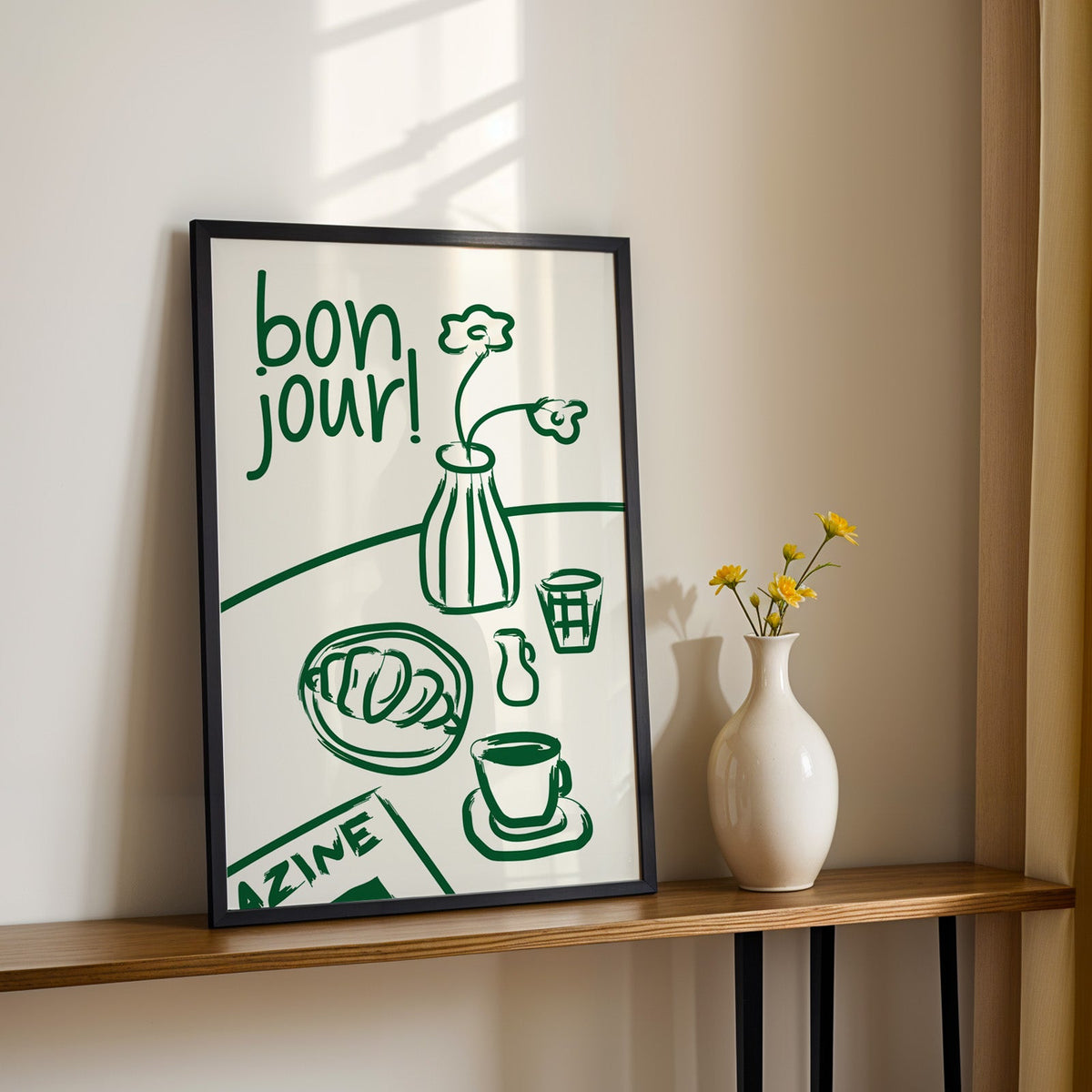 Bon jour breakfast print in a black frame on a console table with yellow daisies