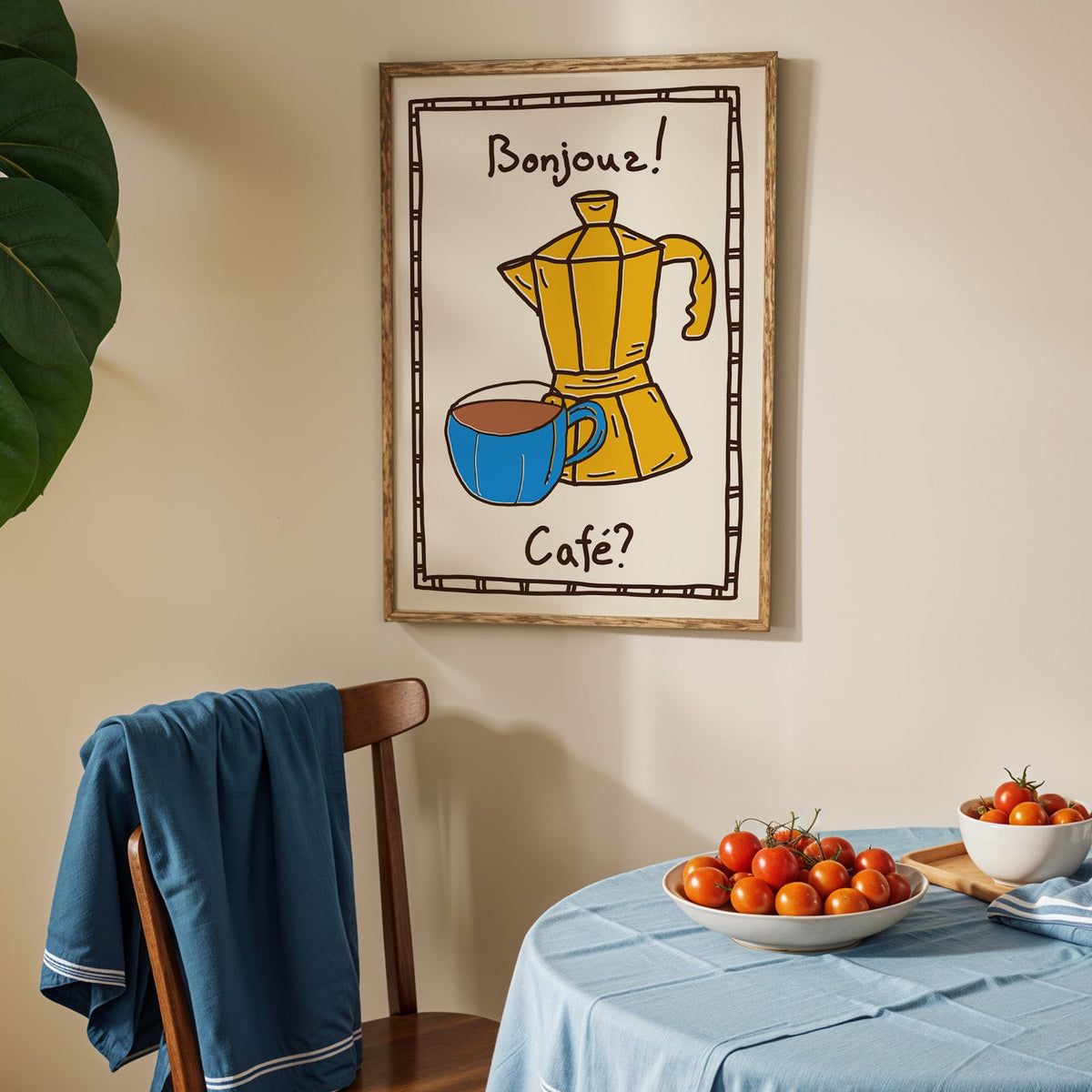Bonjour cafe moka pot print in an oak frame above a blue linen table with tomatoes
