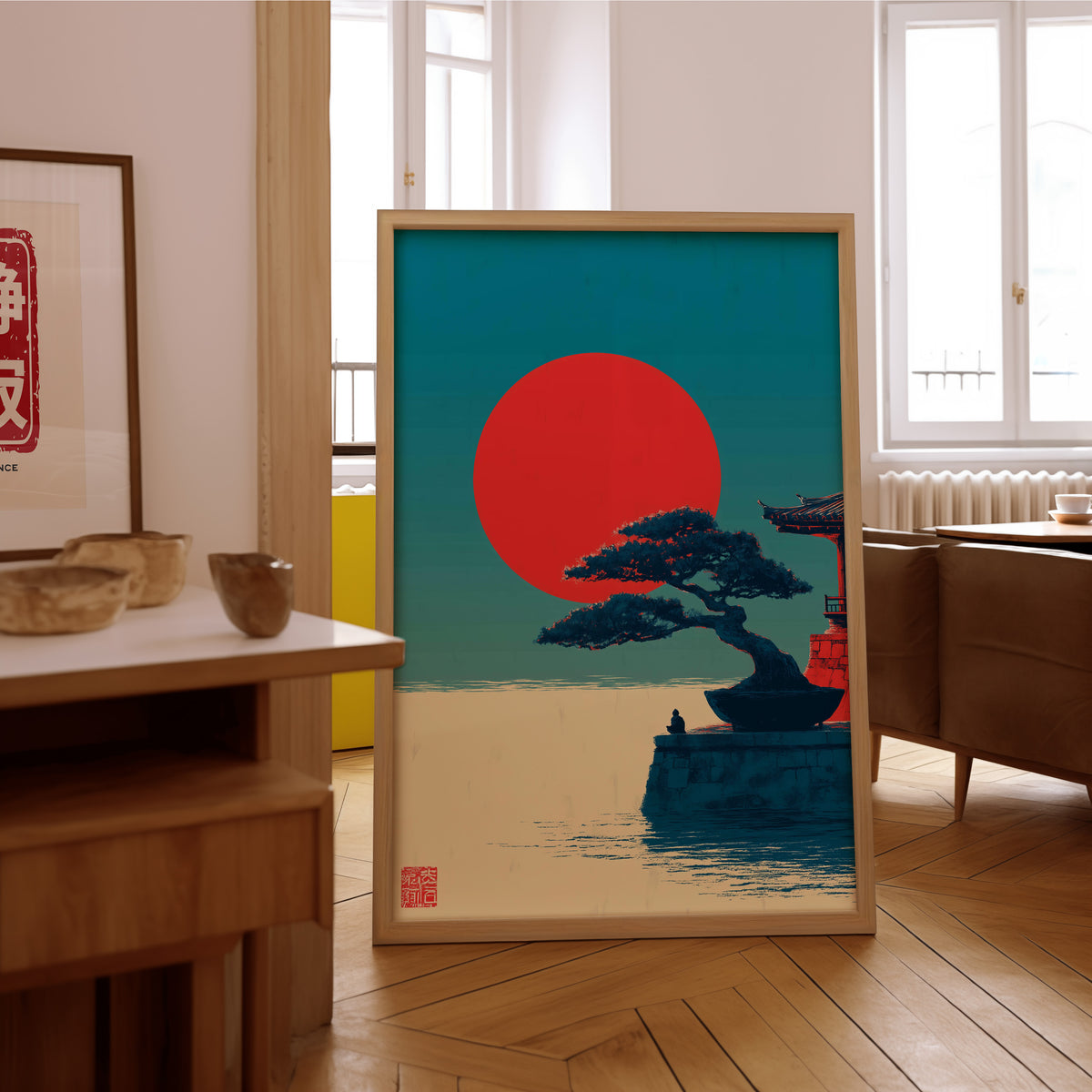 Bonsai pine under red sun print in an oak frame on the parquet floor of a sunlit living room