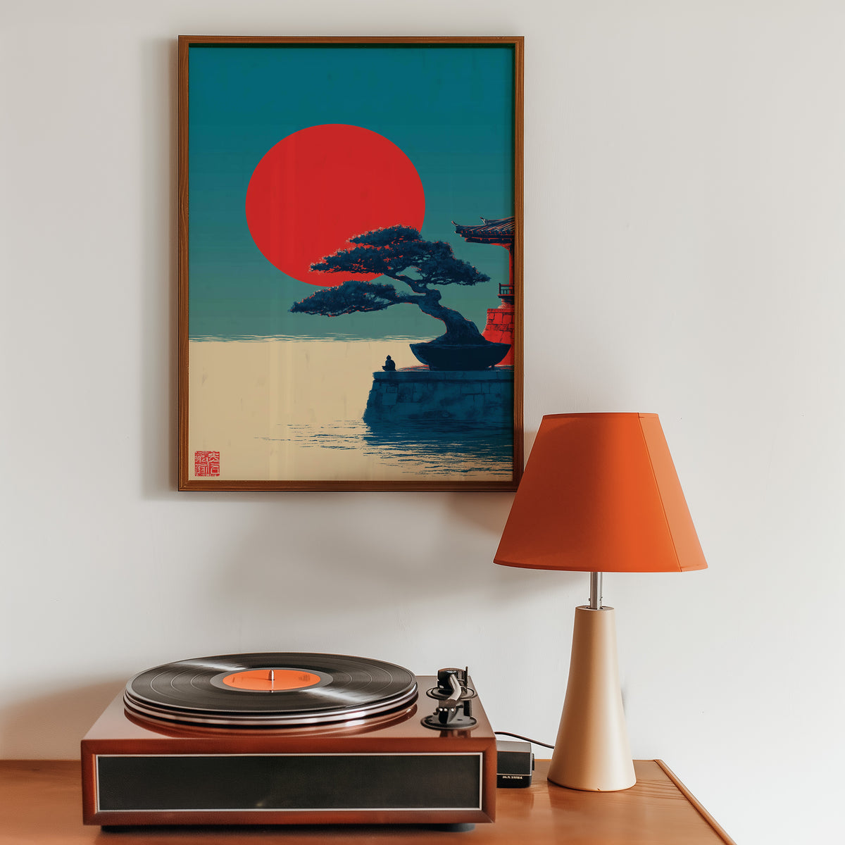 Bonsai pine under red sun print in a walnut frame above a sideboard with a record player