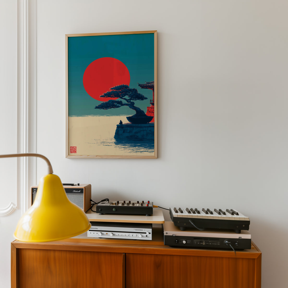 Bonsai pine under red sun print in an oak frame above a teak sideboard with vintage hi-fi