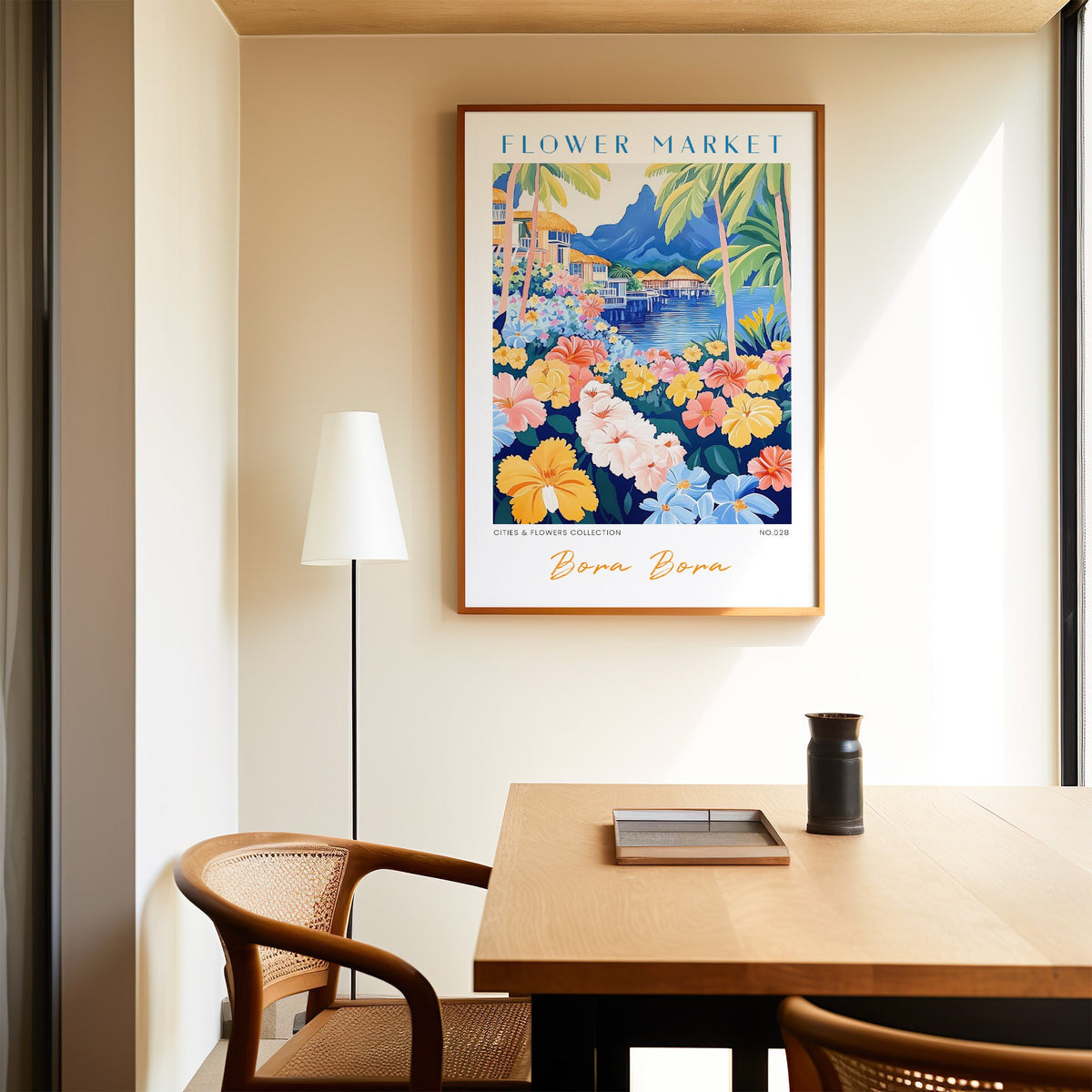Bora Bora flower market print in an oak frame above a dining table and cane chair