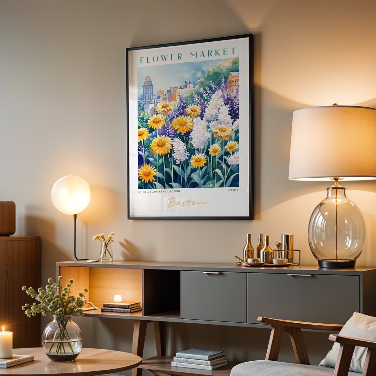 Boston flower market print in a black frame above a grey media console with a glass table lamp