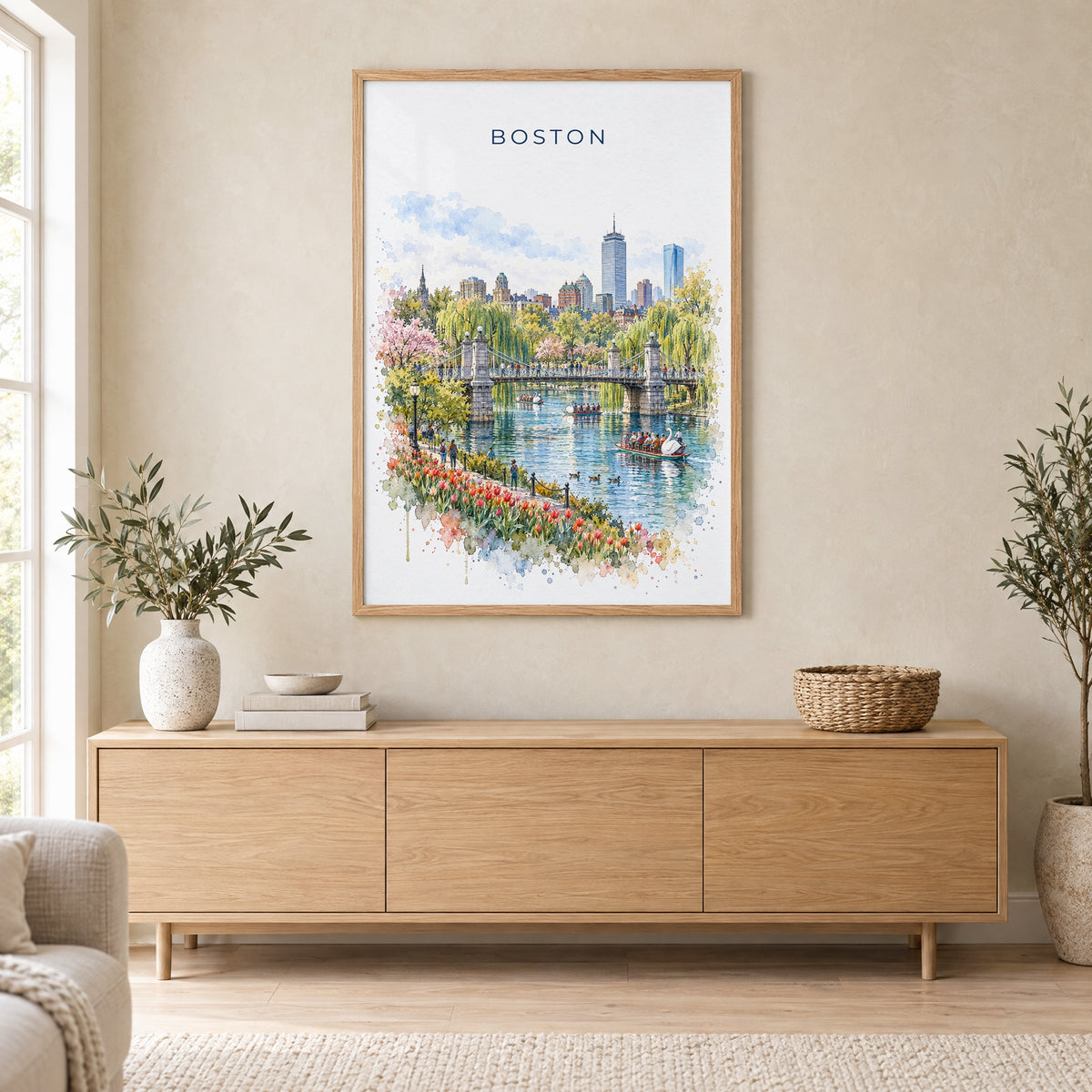 Boston Public Garden watercolor print in an oak frame above a light wood sideboard in a Scandinavian living room