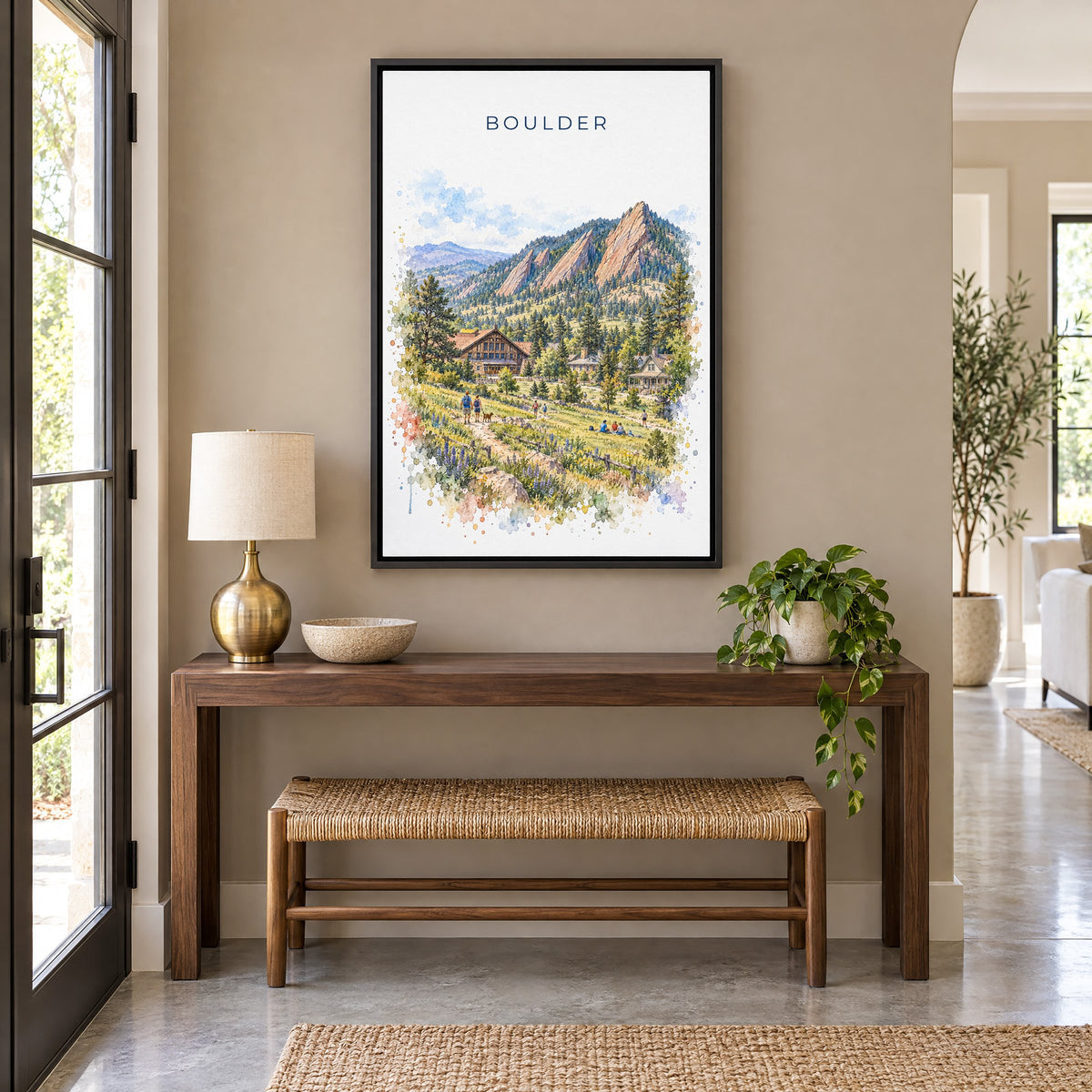 Boulder watercolor print as a black floater canvas above a walnut console and woven bench in an entryway