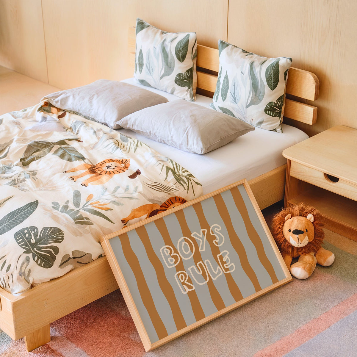 Landscape boys rule wavy stripe nursery print in an oak frame leaning on a kids bed by a lion plush