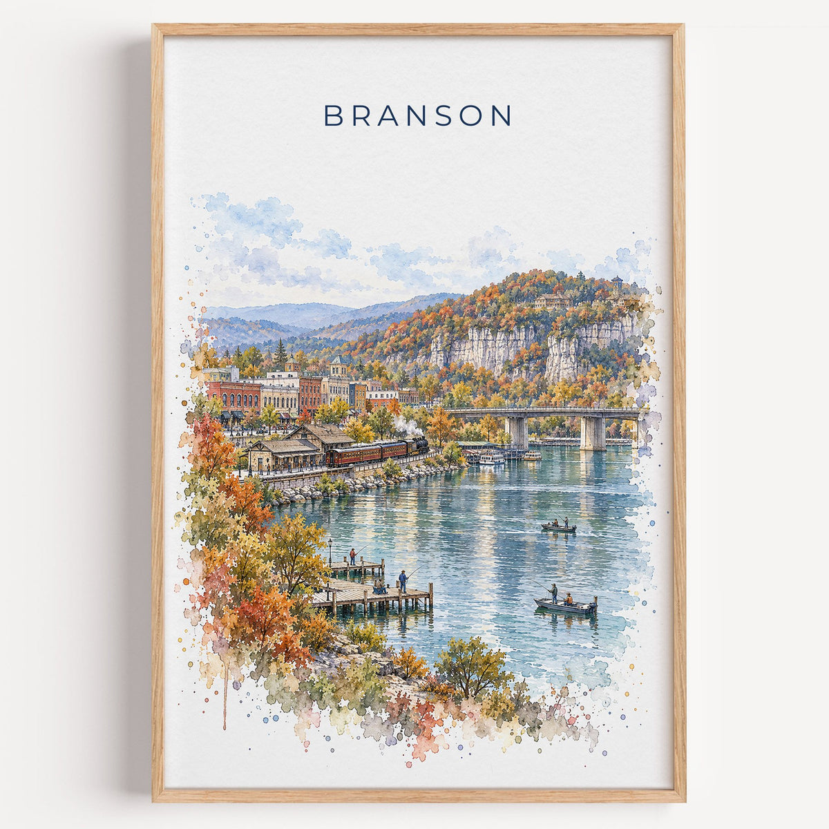 Branson watercolor print in a light oak frame on a plain white wall