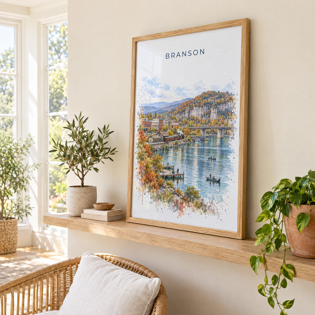 Branson watercolor print in an oak frame on a picture ledge in a sunlit sunroom