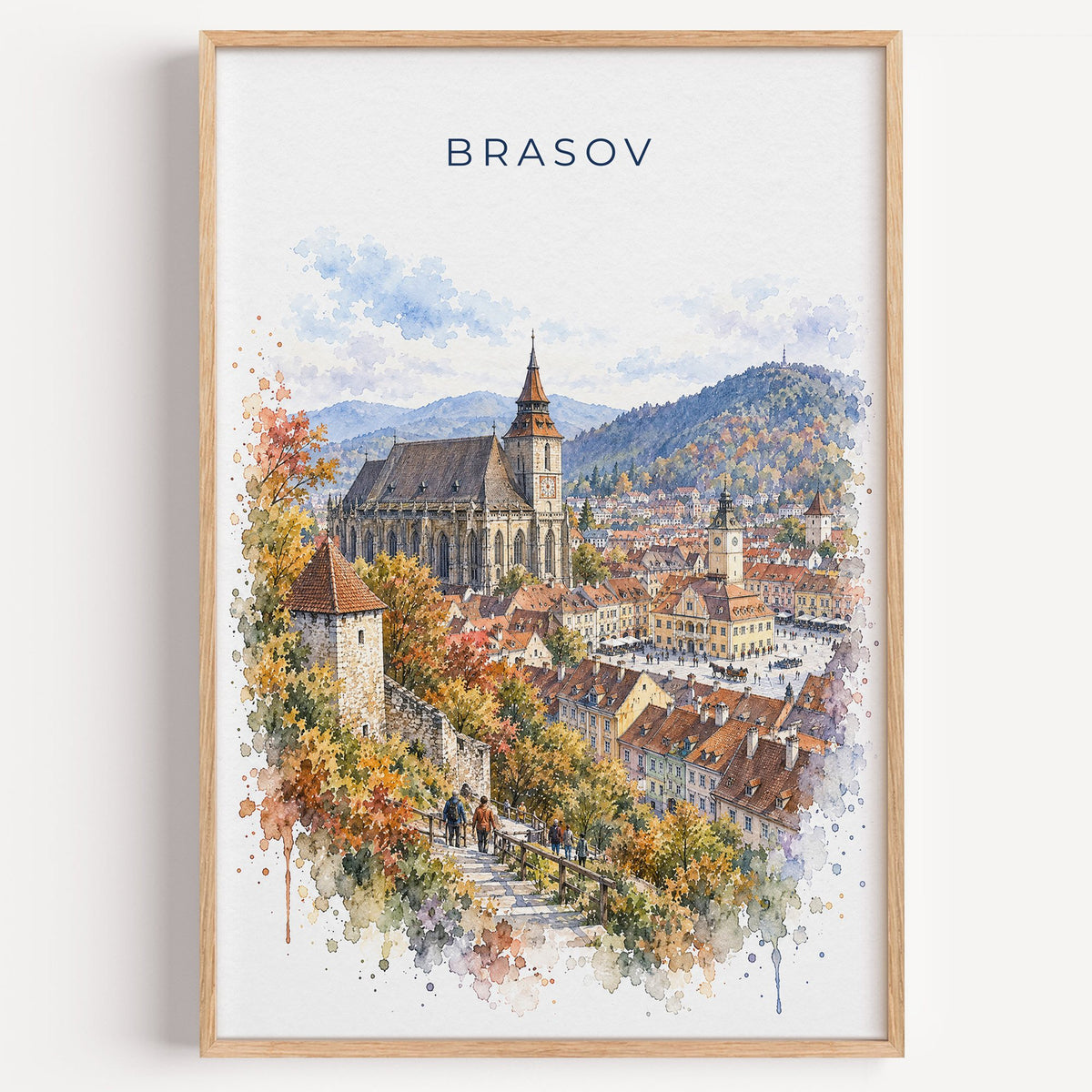 Brasov watercolor print in a light oak frame on a plain white wall
