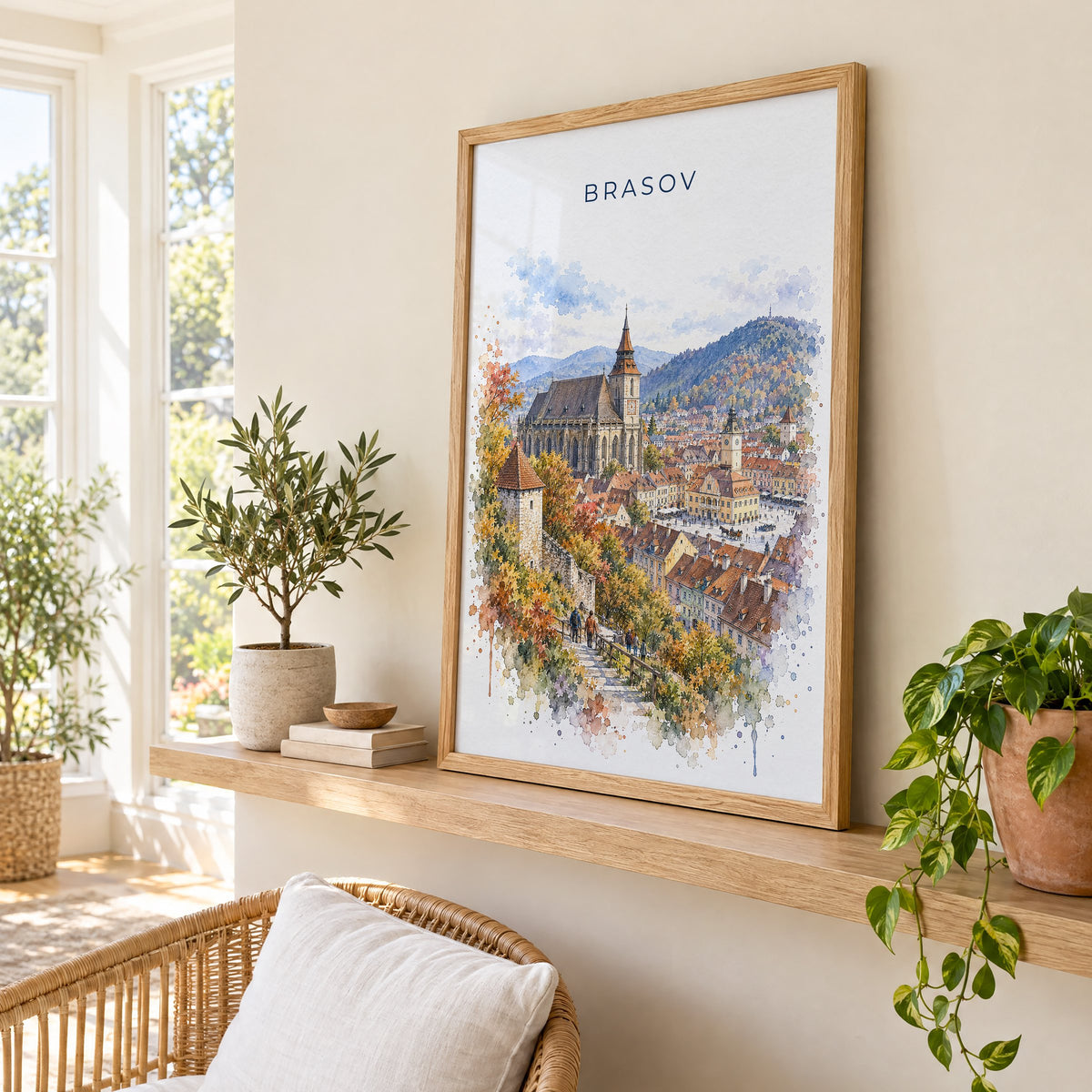 Brasov watercolor print in an oak frame on a picture ledge in a sunlit sunroom