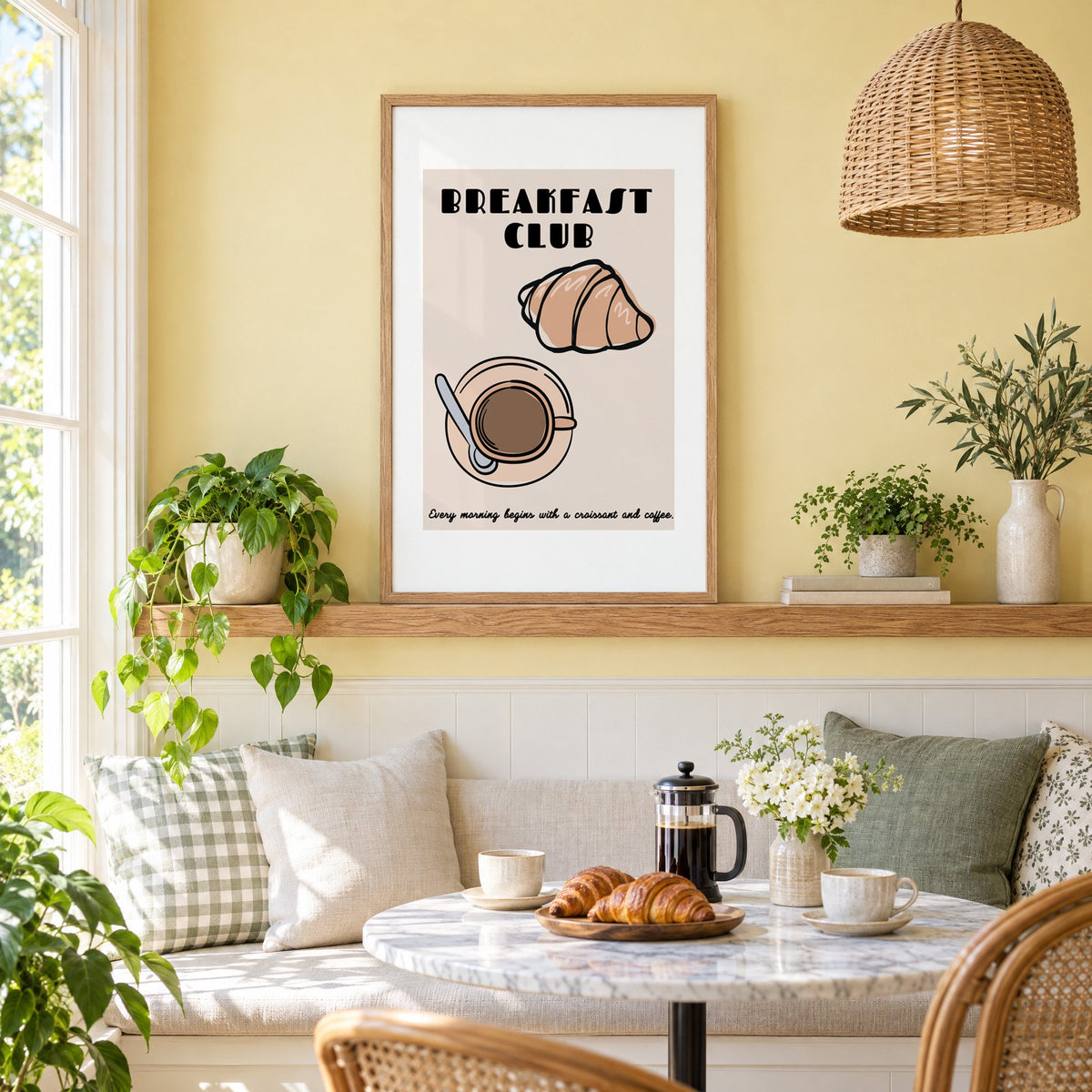Breakfast Club croissant and coffee print in an oak frame on a picture ledge above a sunny breakfast nook