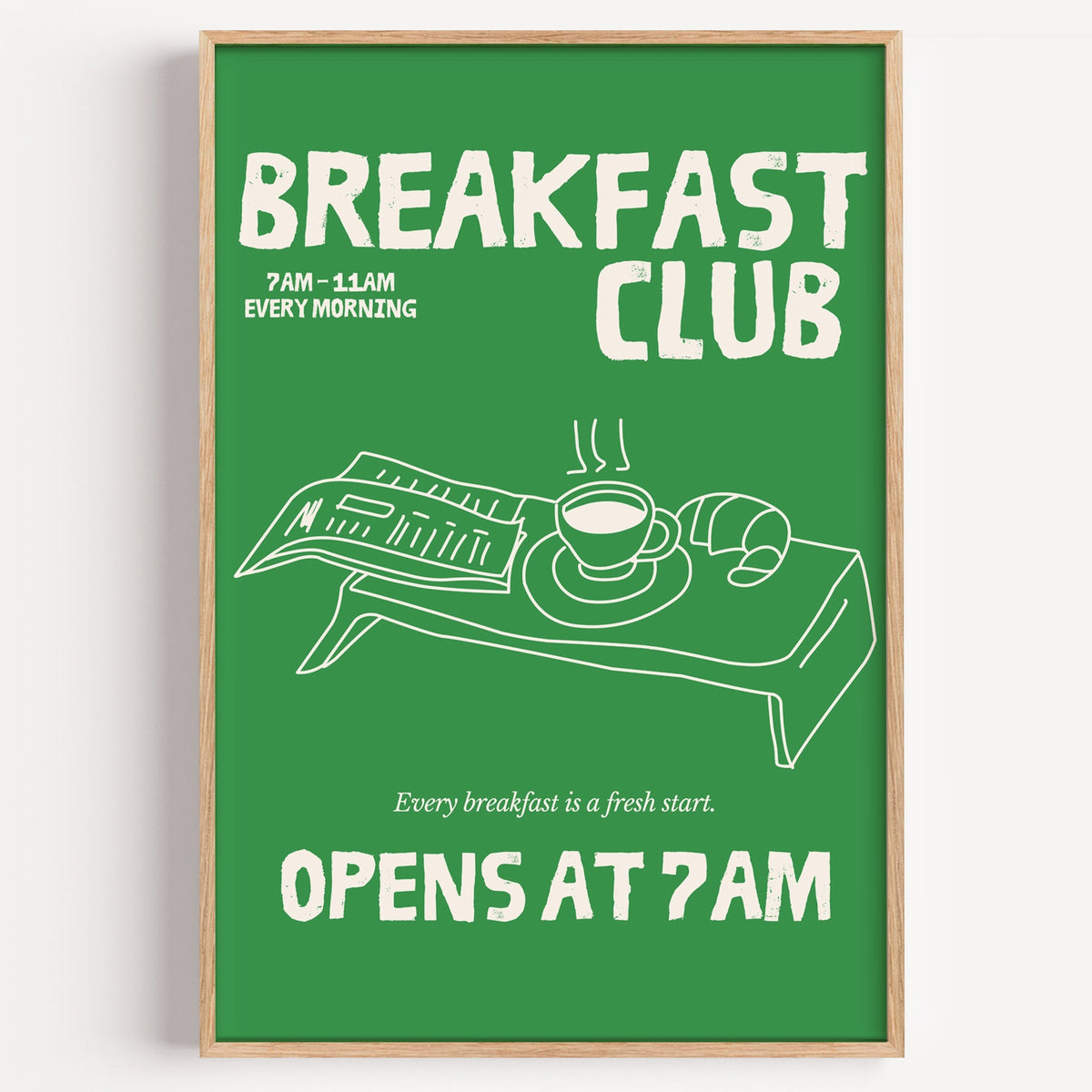 Breakfast Club green tray print in a light oak frame on a plain white wall