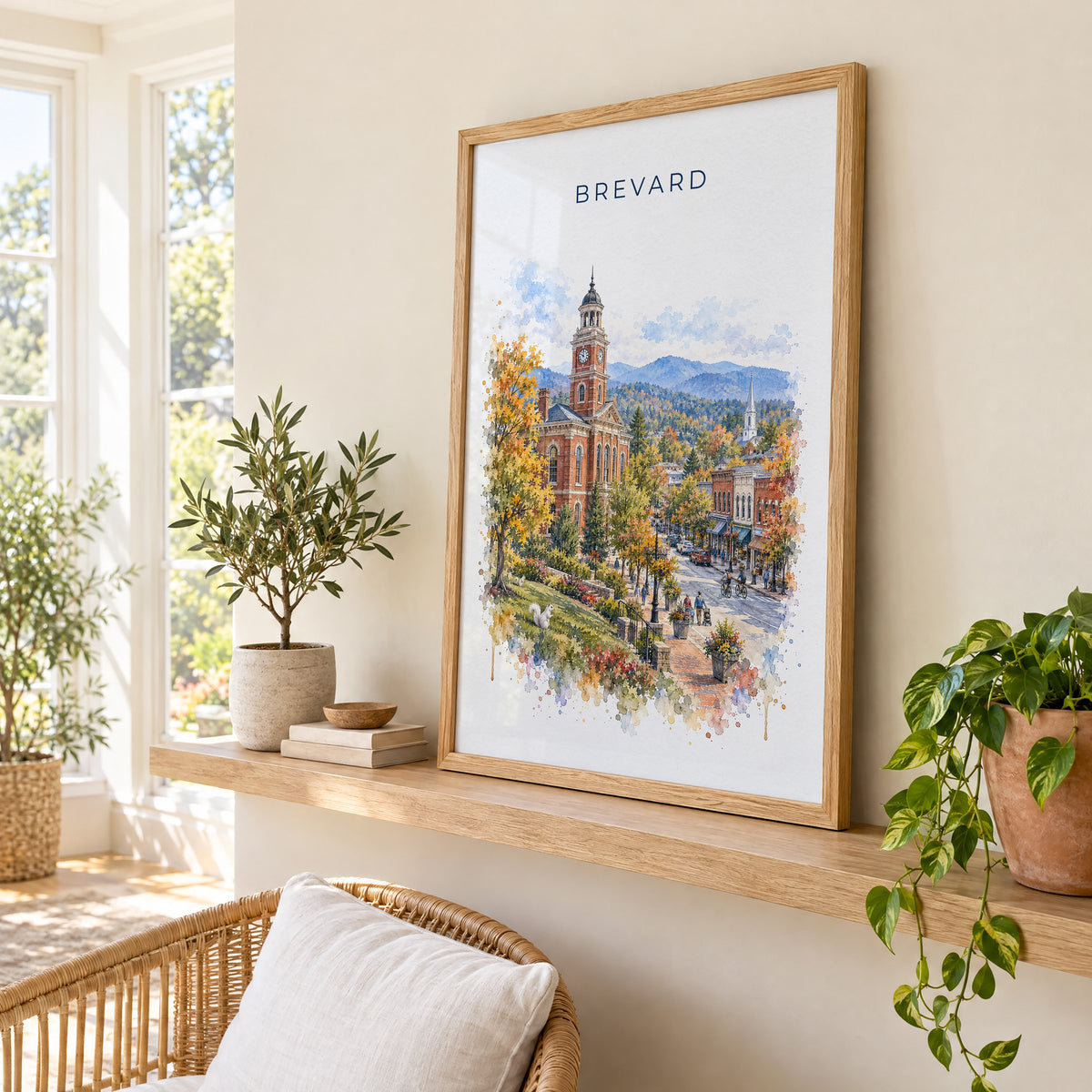Brevard, North Carolina watercolor print in an oak frame on a picture ledge in a sunlit sunroom