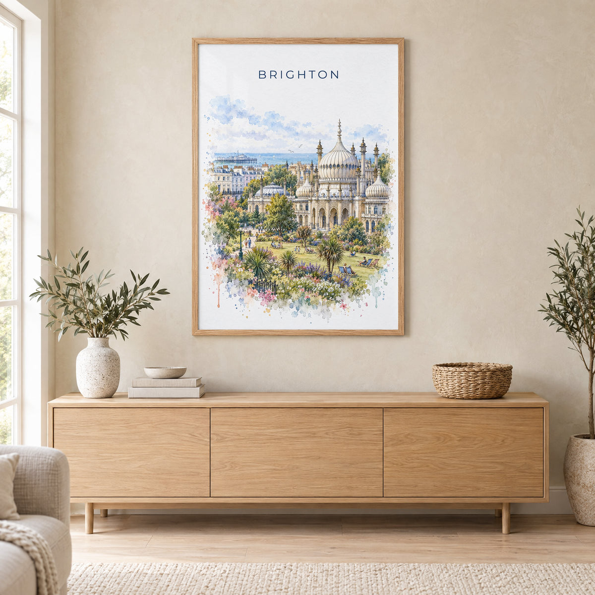 Brighton watercolor print in an oak frame above a light wood sideboard in a Scandinavian living room