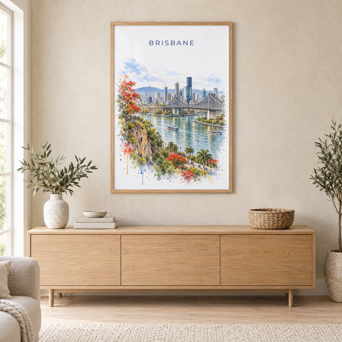 Brisbane watercolor print in an oak frame above a light wood sideboard in a Scandinavian living room