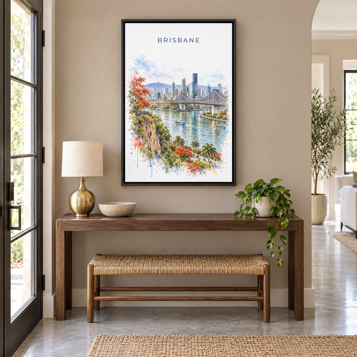 Brisbane watercolor print as a black floater canvas above a walnut console and woven bench in an entryway