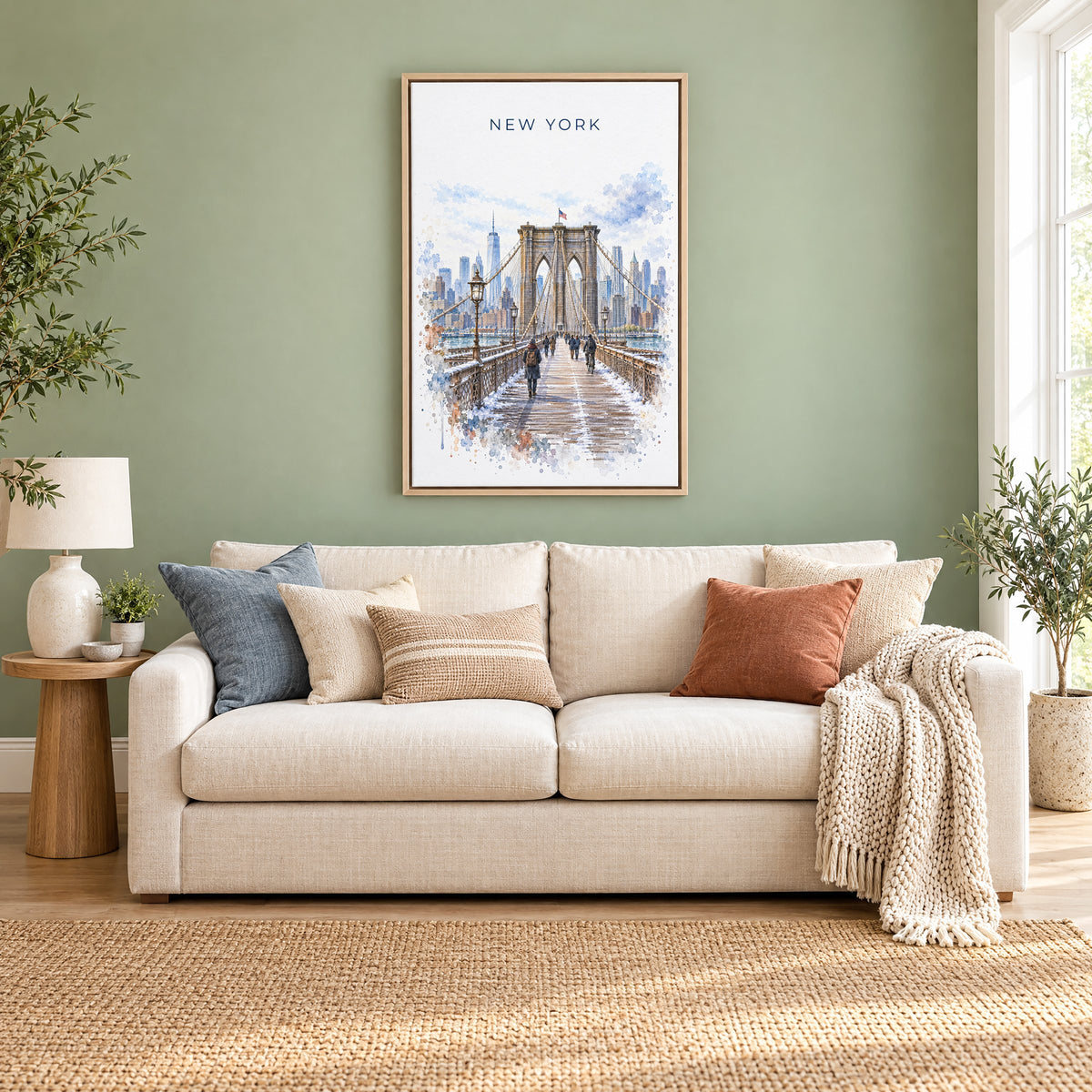 Brooklyn Bridge watercolor print as a natural floater canvas above a cream linen sofa on a sage green wall
